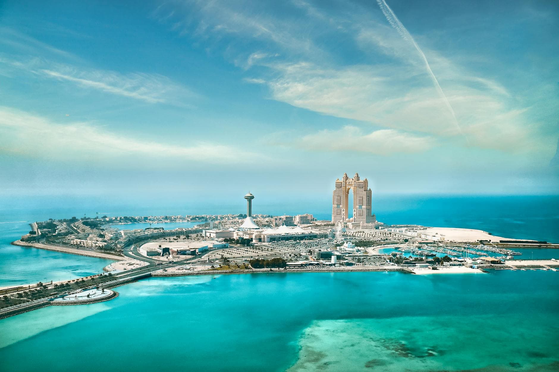Stunning aerial cityscape of Abu Dhabi's waterfront and skyline on a clear day.