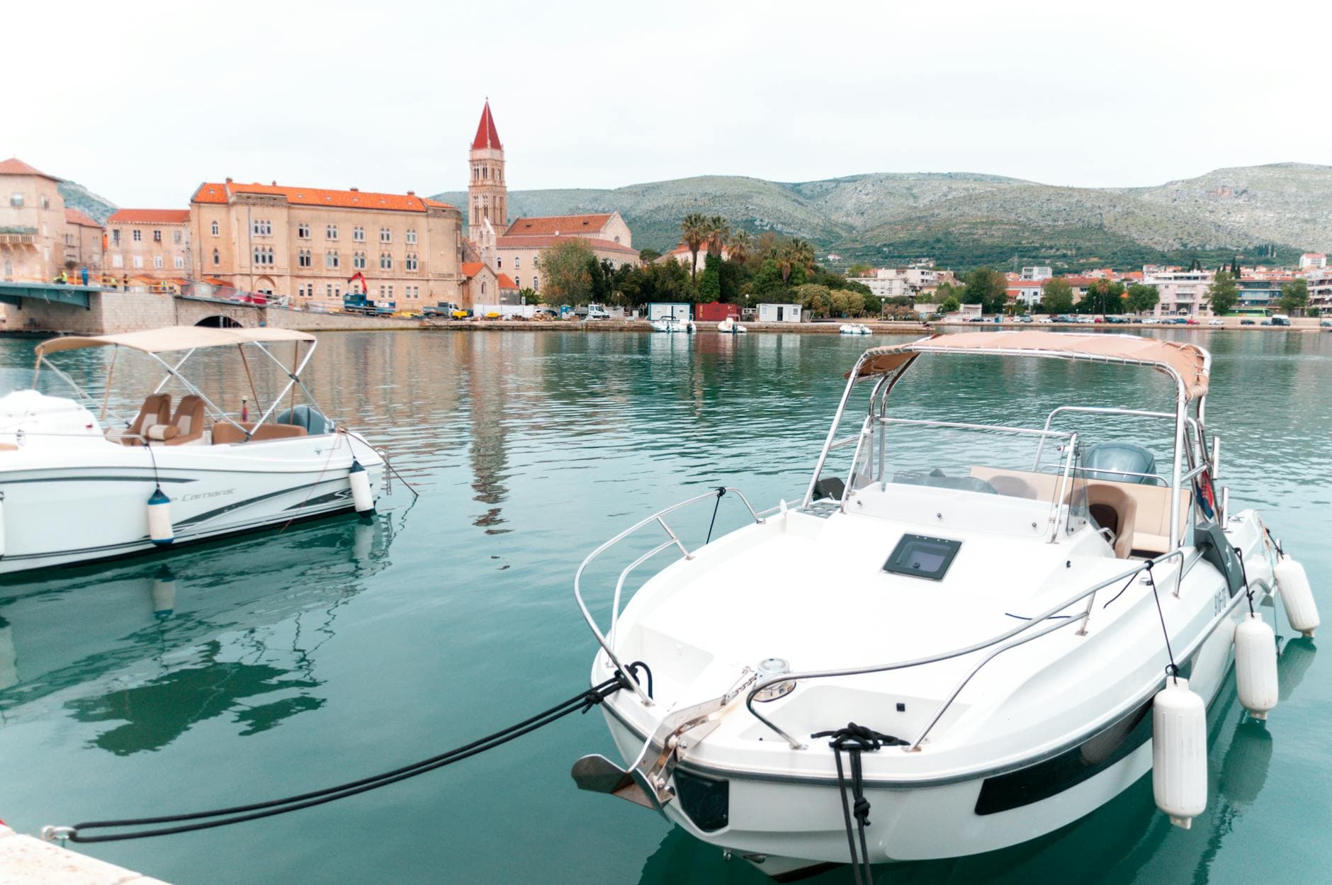Tranquil scene of Trogir harbor with boats and historic architecture in Croatia.