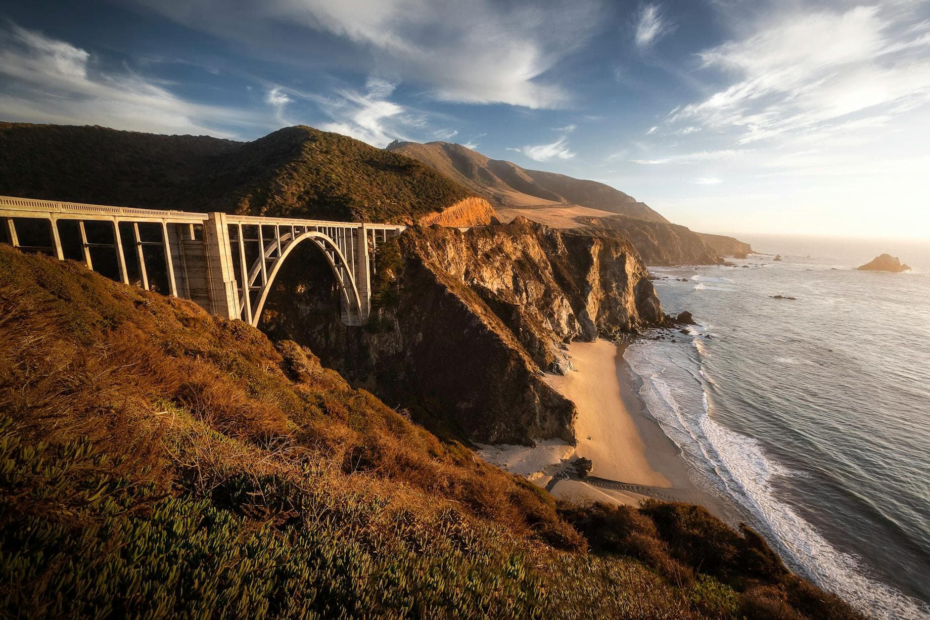 Breathtaking view of Bixby Creek Bridge on the scenic California coast at sunset.