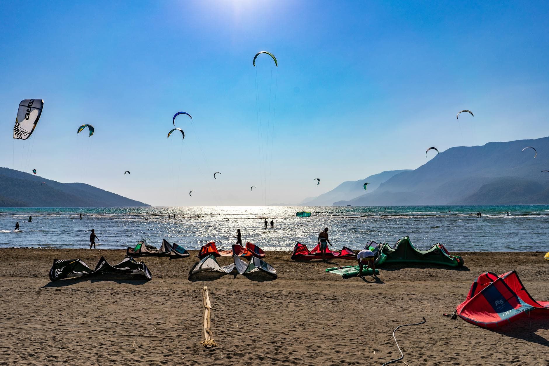 Vibrant scene of kitesurfers enjoying a sunny day at Akyaka Beach.