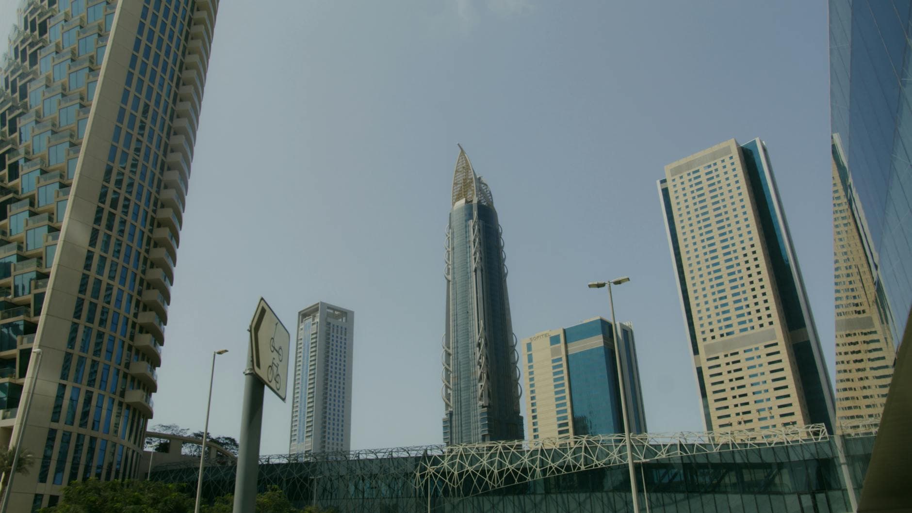 Impressive modern skyscrapers towering against a clear blue sky in a bustling cityscape.