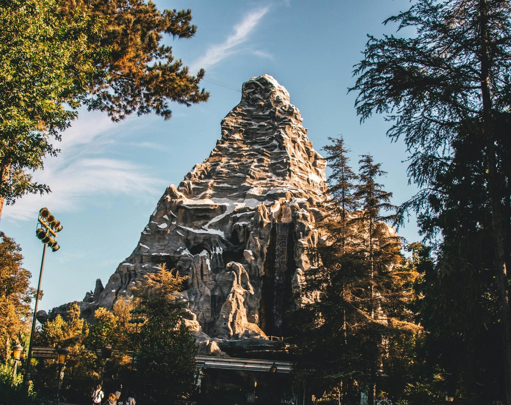 Beautiful view of the iconic Matterhorn Mountain at Disneyland with clear skies and trees.