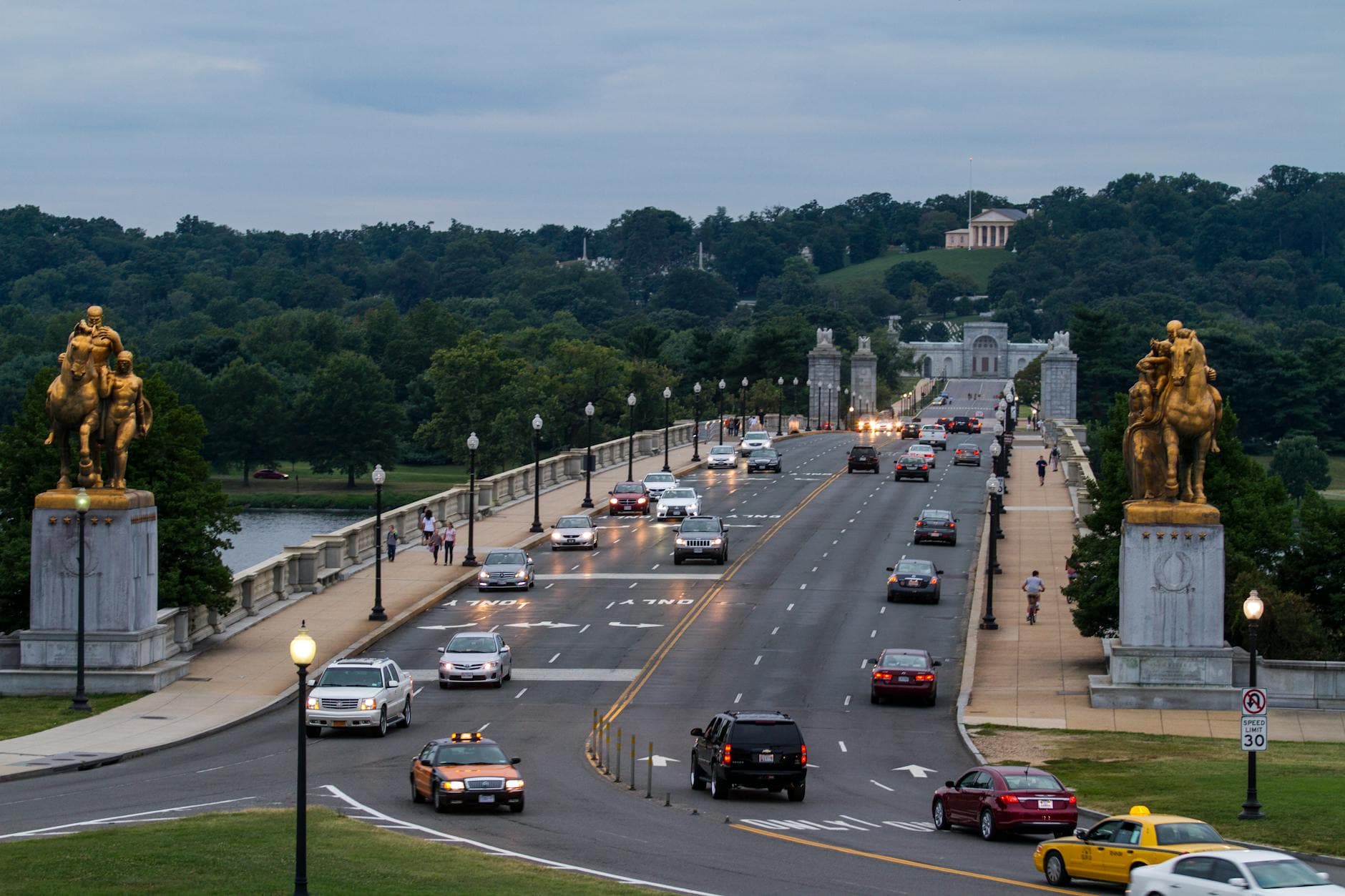 View of Arlington Memorial Bridge in Washington, DC, with cars driving at dusk.