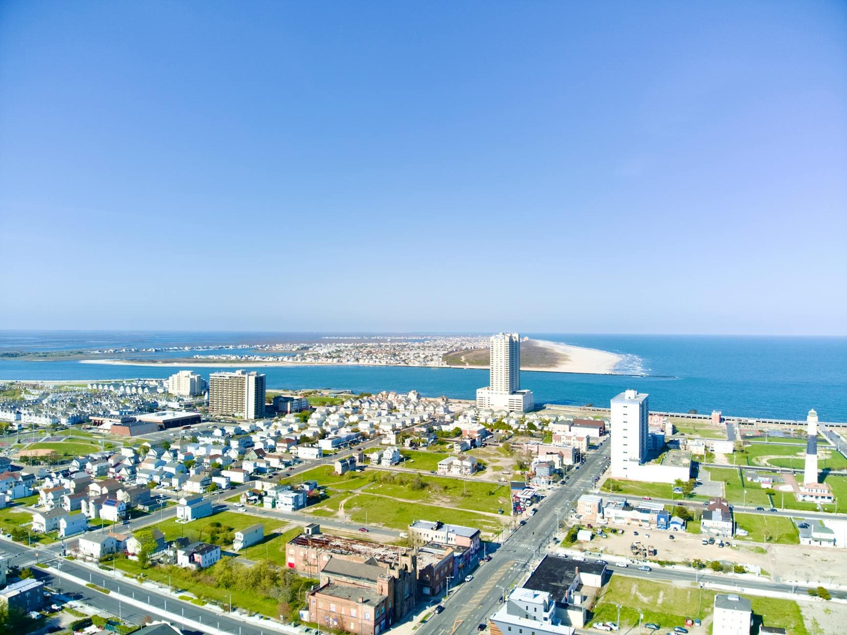 A stunning aerial shot showcasing Atlantic City's skyline and coastline on a clear summer day.