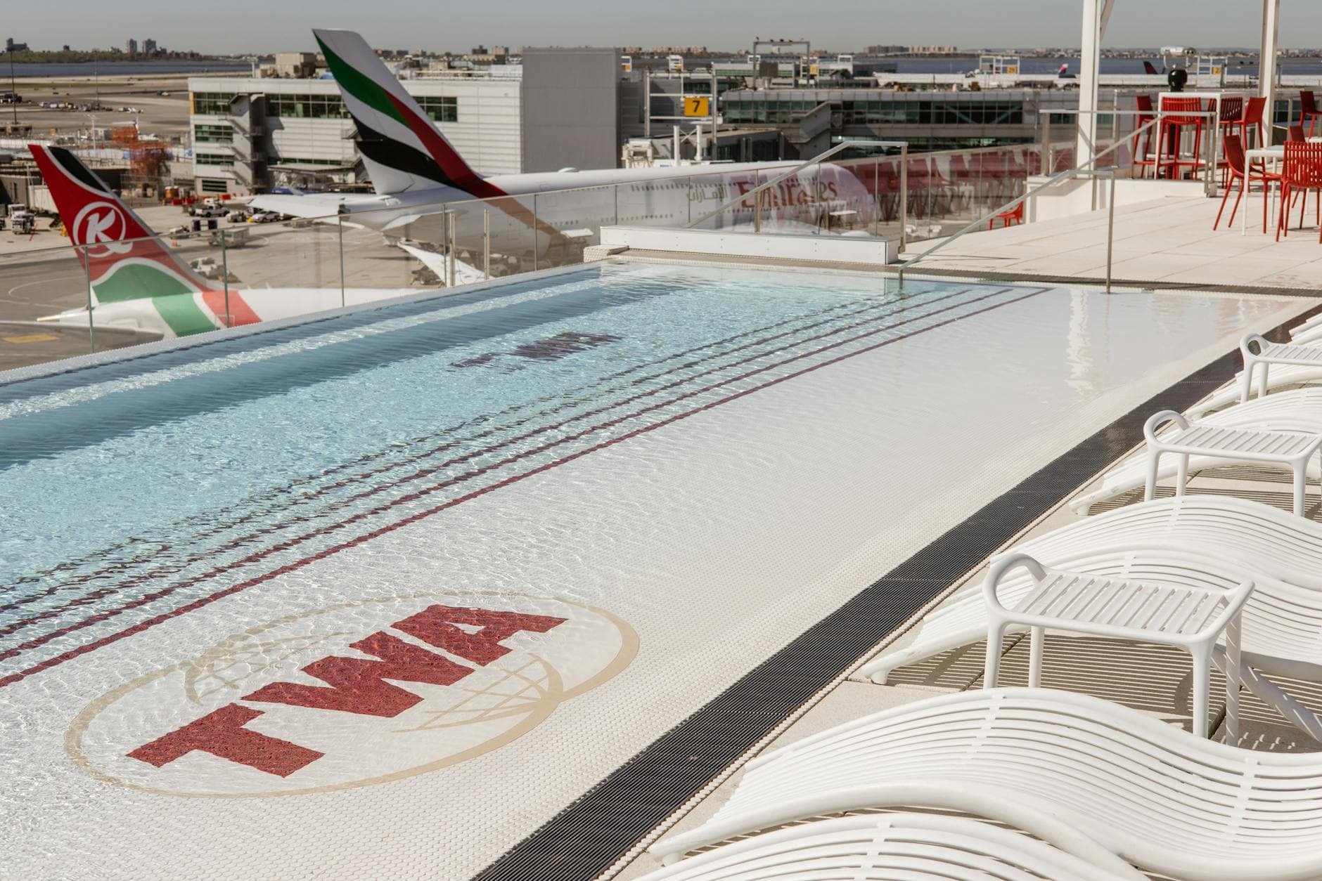 Scenic view of TWA Hotel rooftop pool with airplanes at JFK Airport, New York.