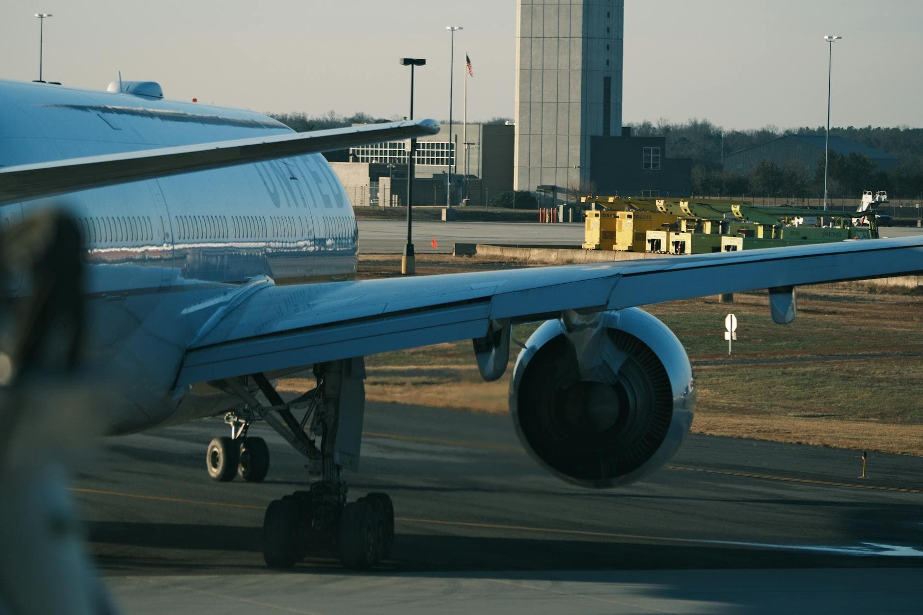 Close-up view of a commercial airliner on the airport tarmac under clear skies.
