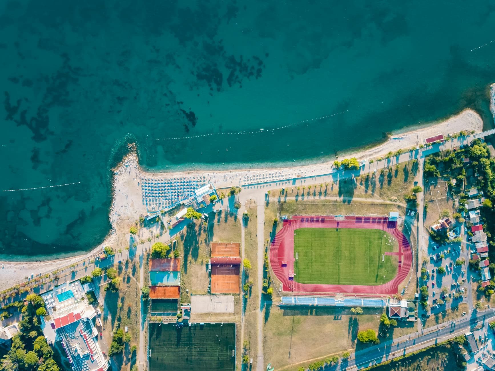 Stunning aerial view of Bar beach and sports stadium in Montenegro, showcasing vibrant coastal scenery.