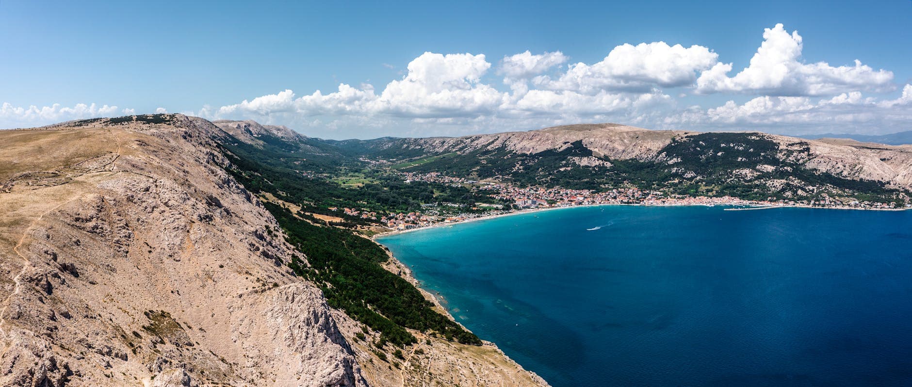 Panoramic aerial view of Baška in Croatia with coastline and mountains.