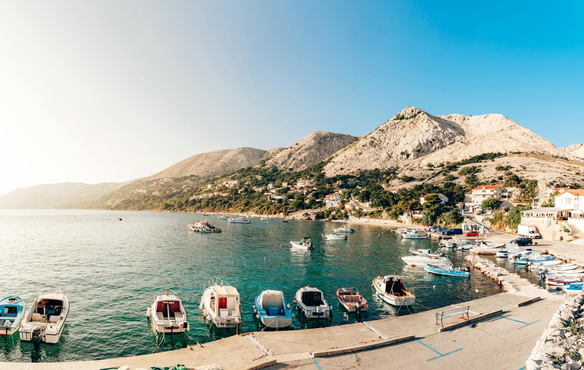 A serene view of boats docked at Baska Beach on Krk Island, Croatia.