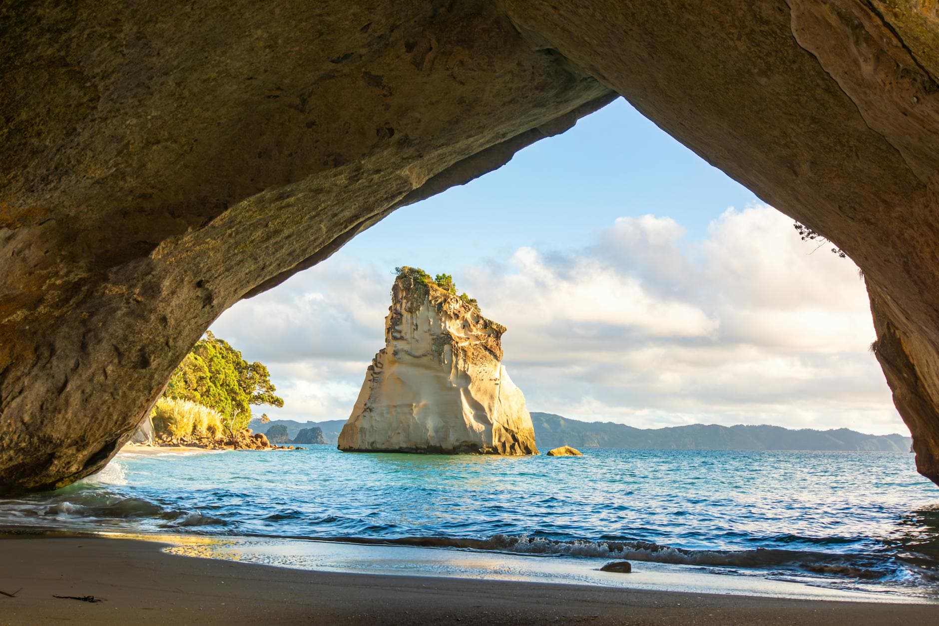 Scenic view of Cathedral Cove beach and rock formations in New Zealand.