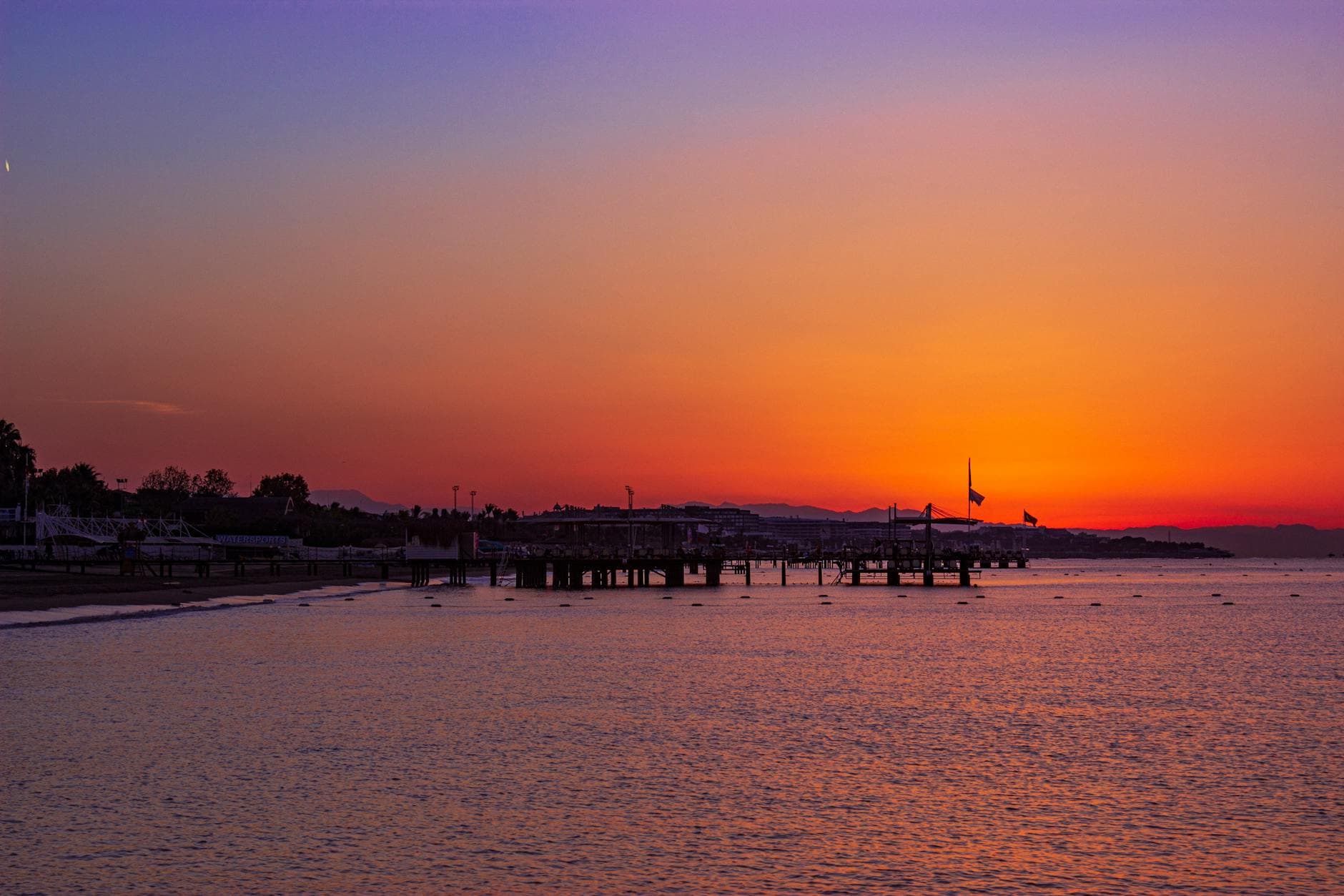 Captivating sunset over Belek Beach in Antalya, featuring a serene ocean view and vibrant sky.