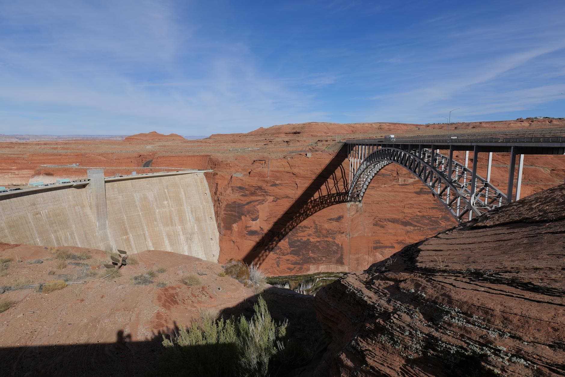 Scenic view of Glen Canyon Dam and Arch Bridge with blue skies in Arizona.