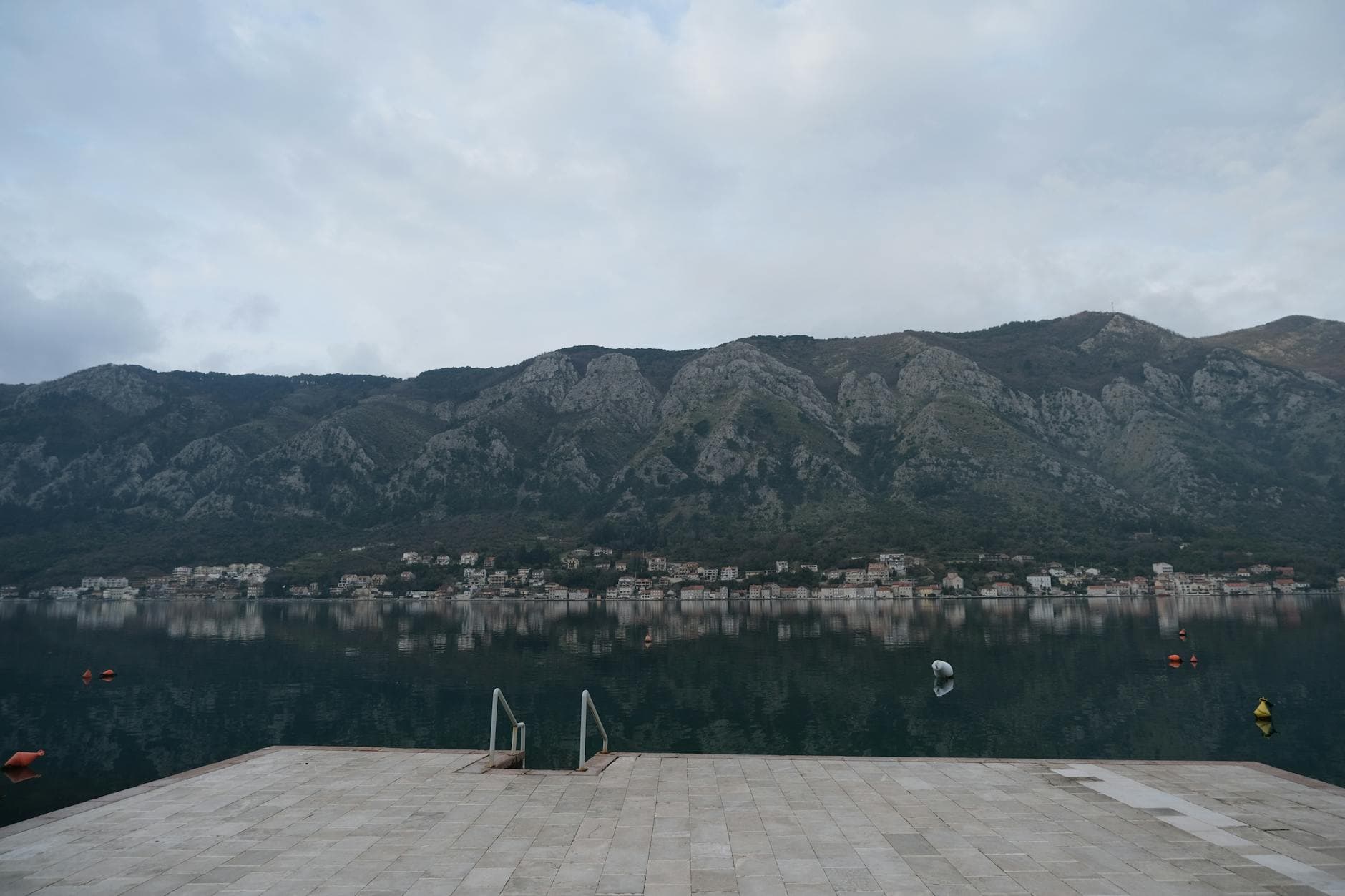 Experience the serene waters and stunning mountainous backdrop of Kotor Bay in Montenegro.