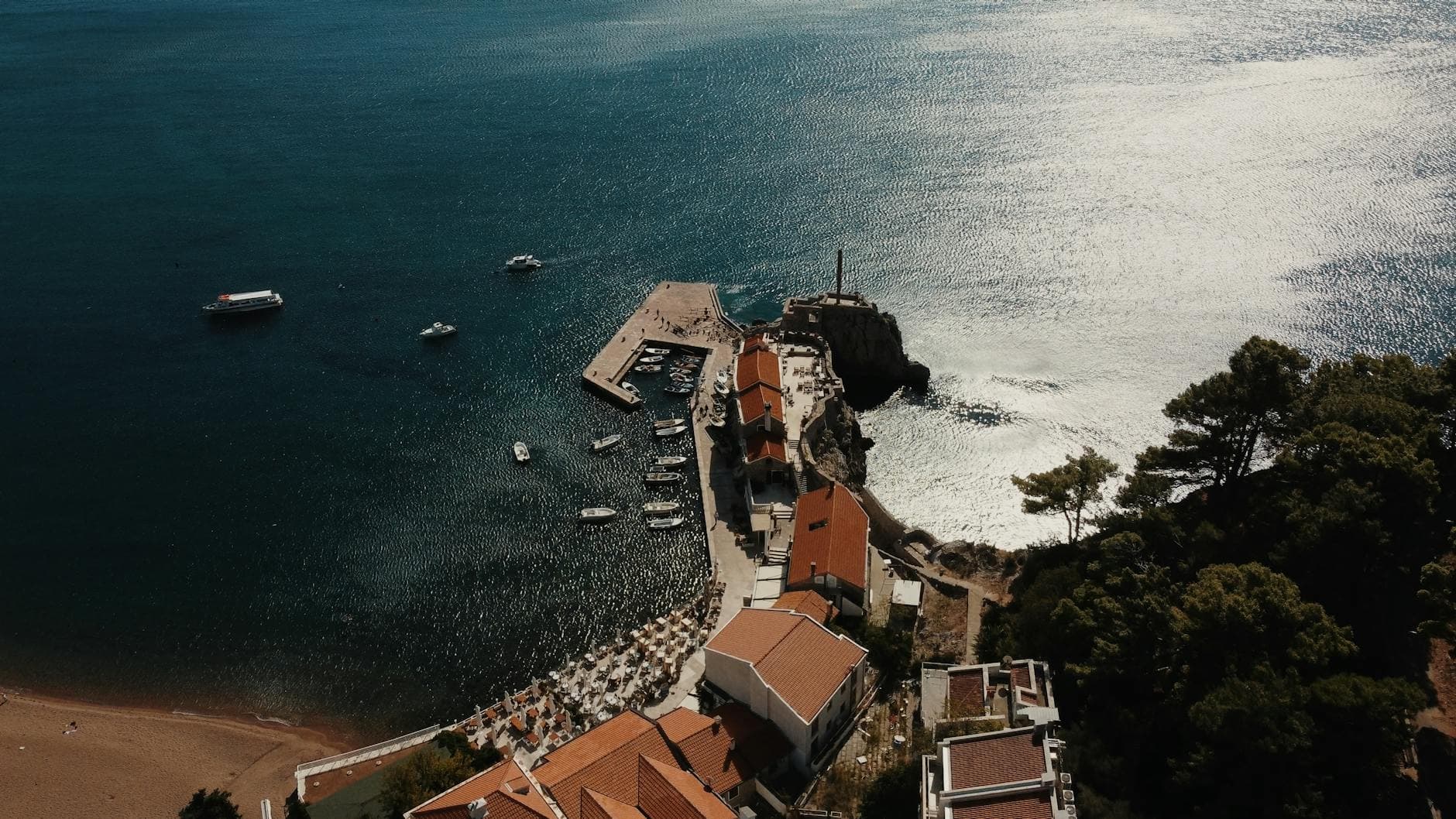 A stunning aerial view of Petrovac coastline, showcasing the Adriatic Sea and harbor.
