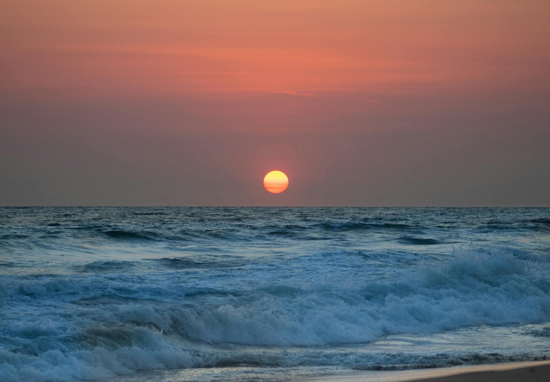 A tranquil sunset over the waves at Boca del Cielo beach, capturing nature's serene beauty.