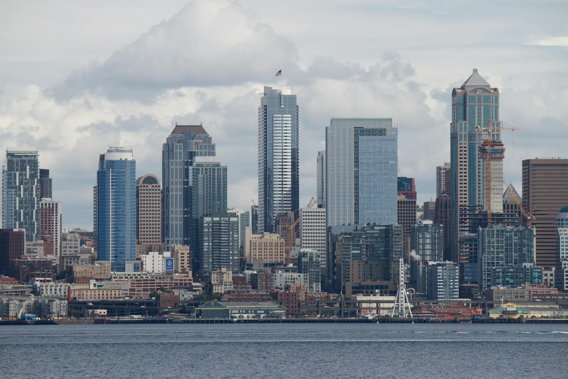A stunning view of the Seattle skyline with skyscrapers and the iconic Space Needle across the waterfront.