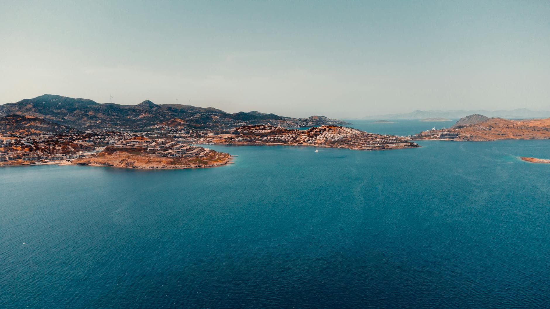 Stunning aerial view of Bodrum's coastline with clear blue waters and scenic hills in Turkey.