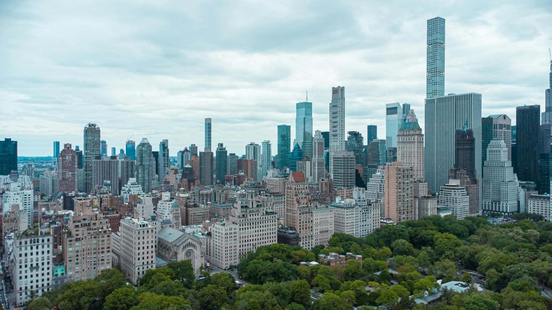 A panoramic view of New York City's skyline with Central Park in the foreground, capturing skyscrapers and urban beauty.