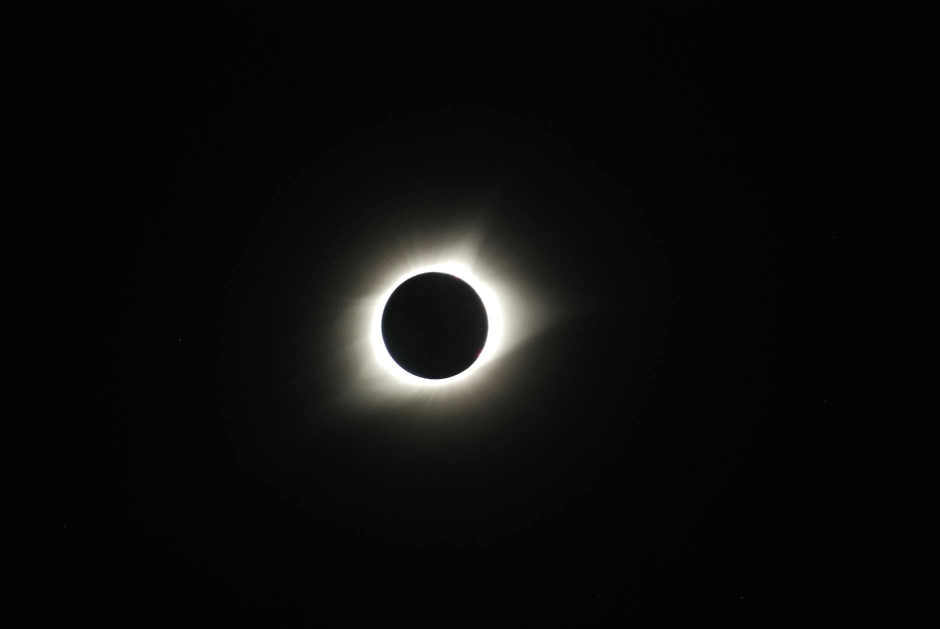Captivating image of a total solar eclipse showcasing the sun's corona in the dark sky.