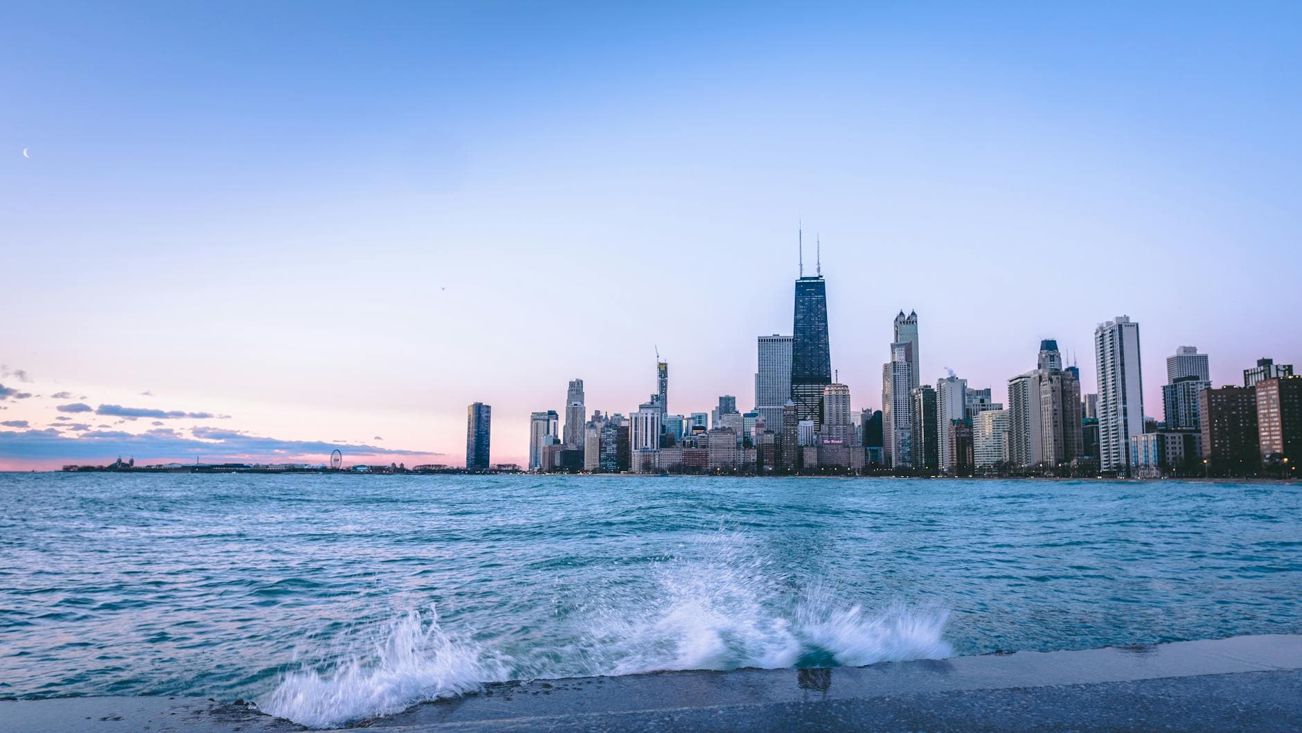 Explore the iconic Chicago skyline at dusk with a stunning waterfront view and splashing waves.