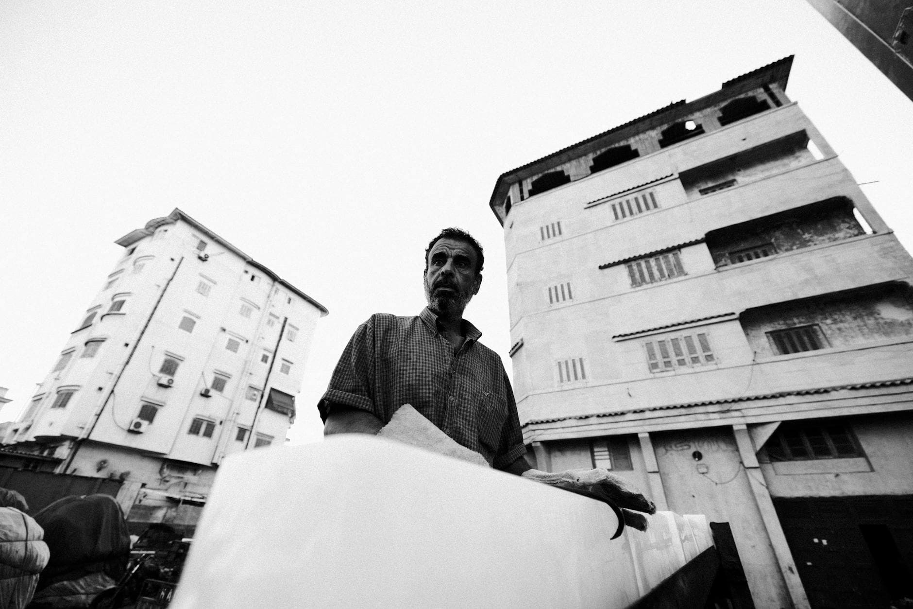 Black and white photo of a man outdoors in Damietta, Egypt.