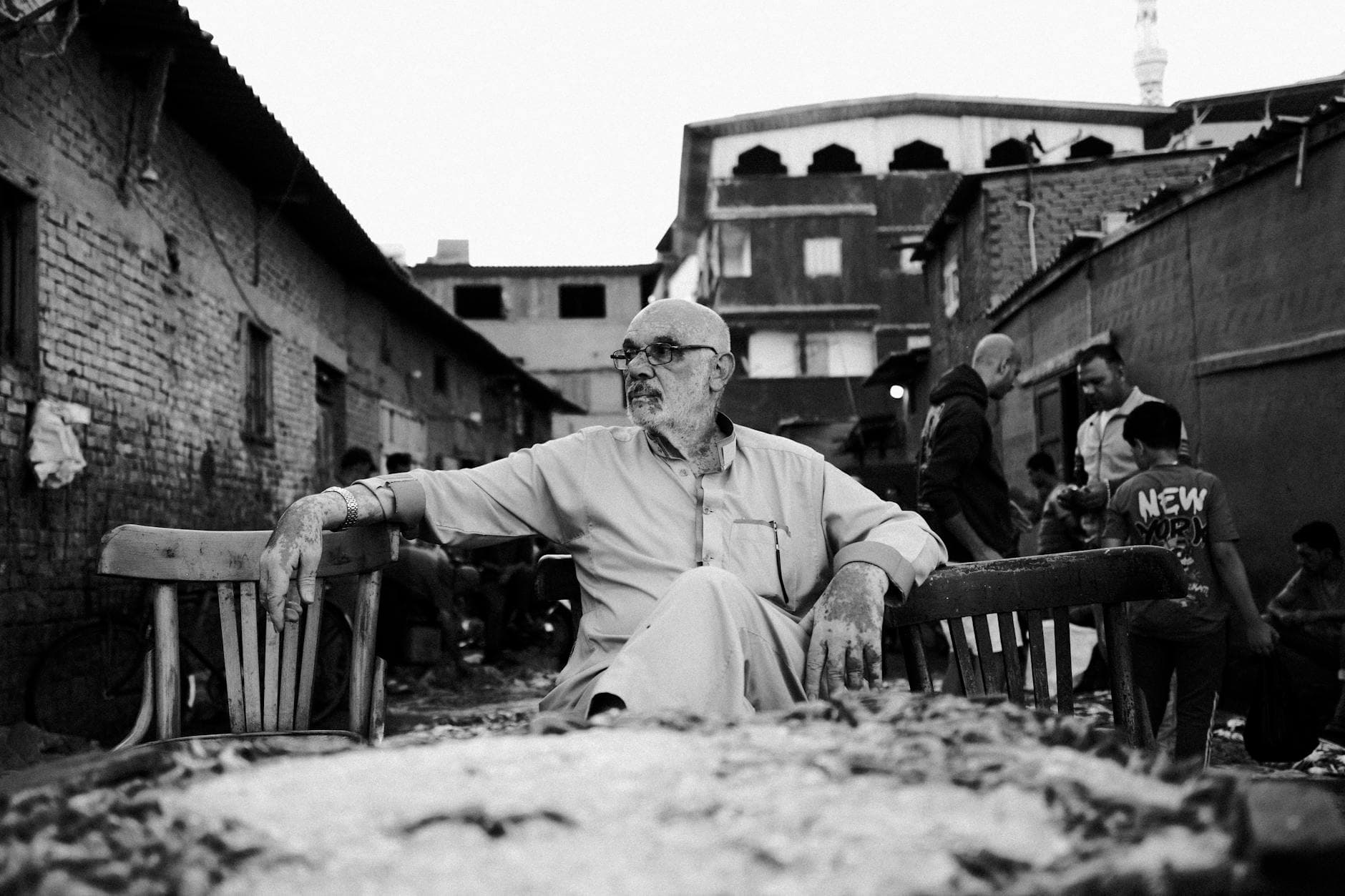 Candid black and white photo of people at a bustling fish market in Damietta, Egypt.