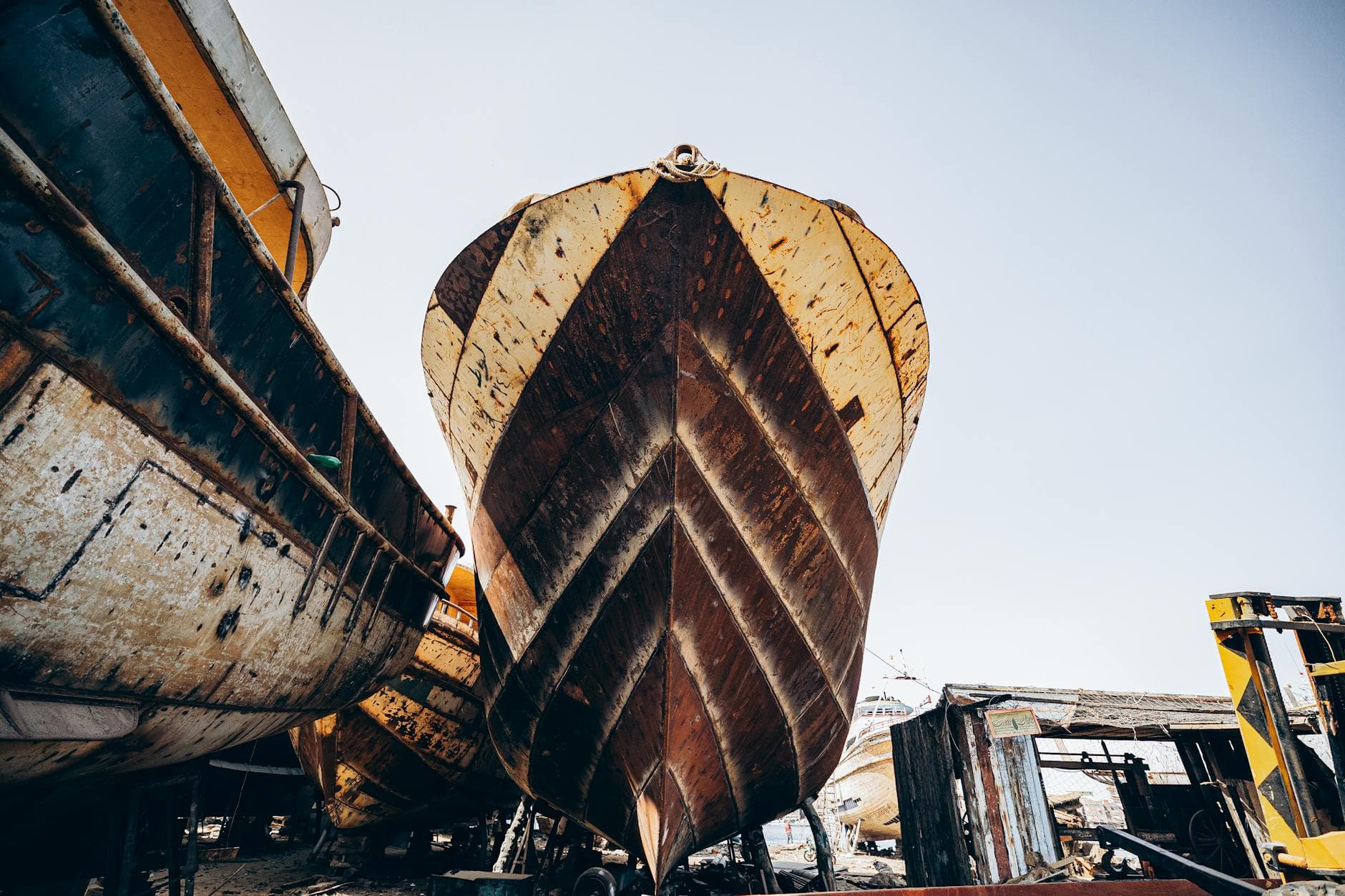 A close-up view of rustic boats at a shipyard in Damietta, Egypt, showcasing nautical craftsmanship.
