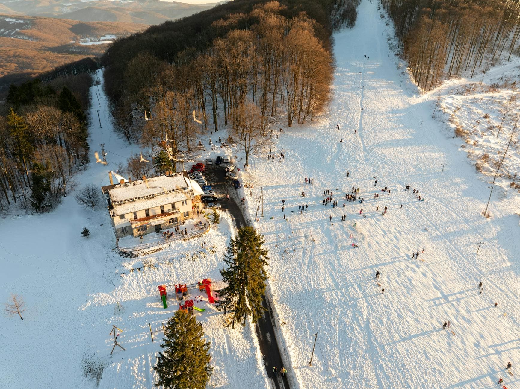 Aerial view of a snowy winter landscape in Daruvar, Croatia, with people enjoying outdoor activities.