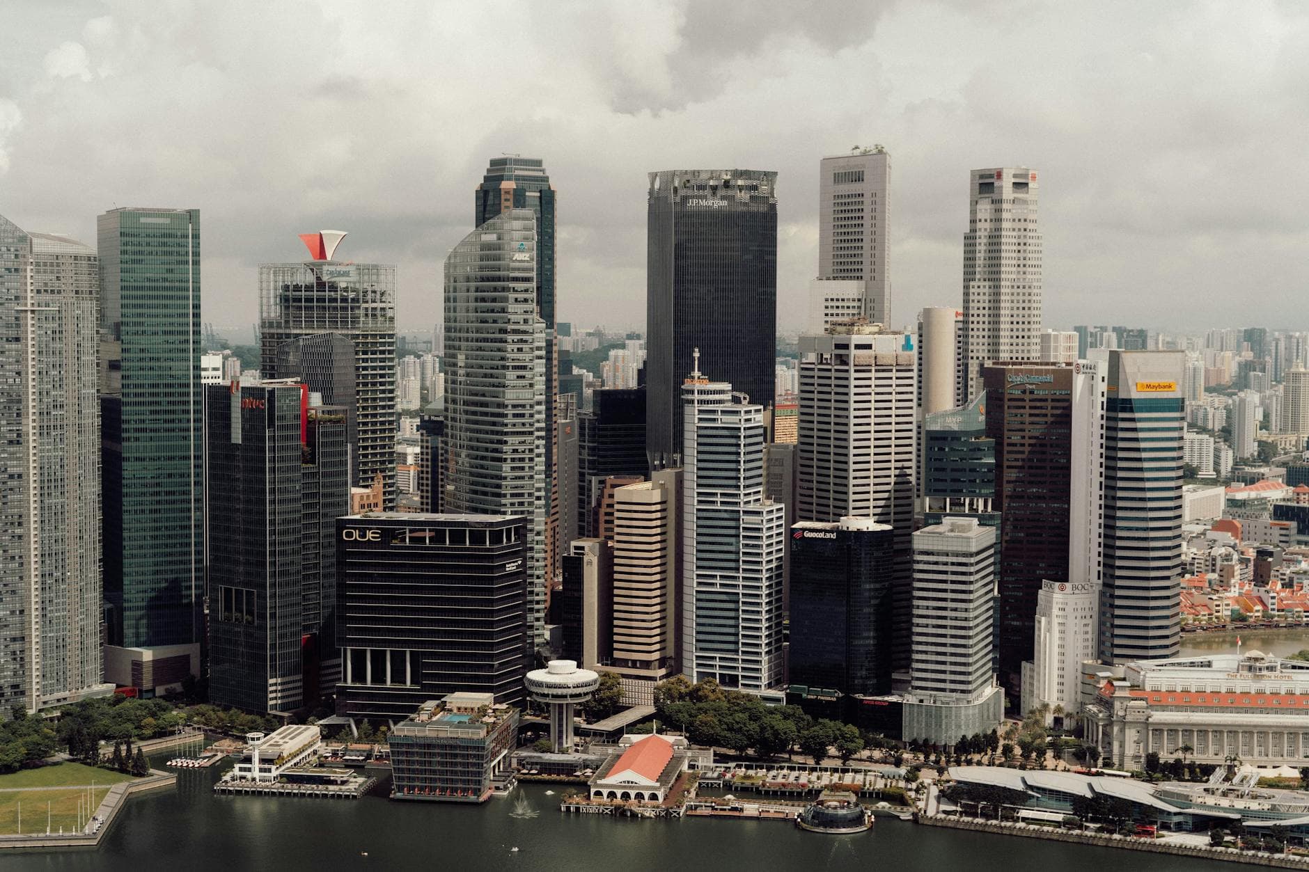Aerial view of Singapore's modern skyline with iconic skyscrapers and waterfront.