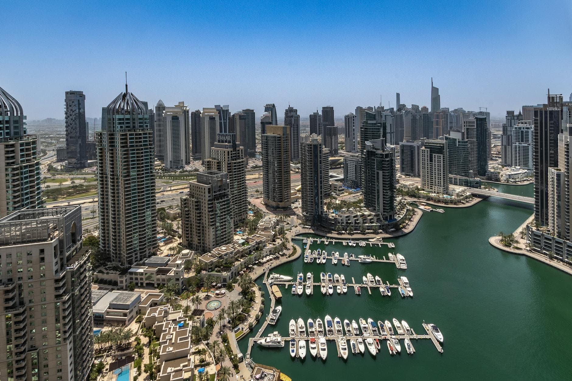 Stunning aerial view of Dubai Marina's skyline and waterfront, showcasing modern architecture and luxury yachts.