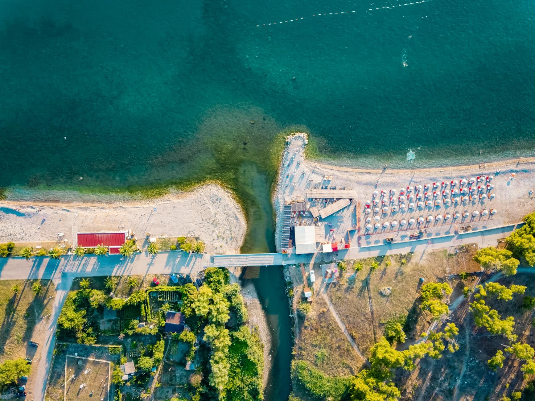A breathtaking aerial view of Bar beach and bridge in Montenegro's summer landscape.