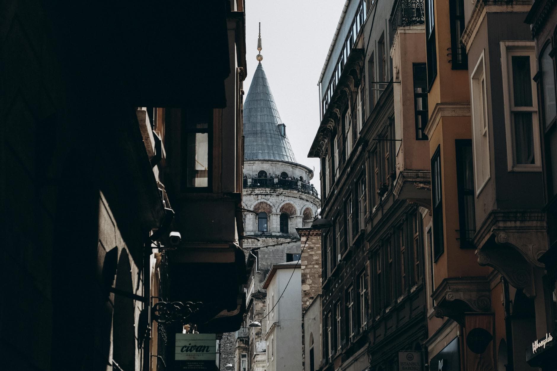 An iconic view of Galata Tower nestled between historic Istanbul buildings.