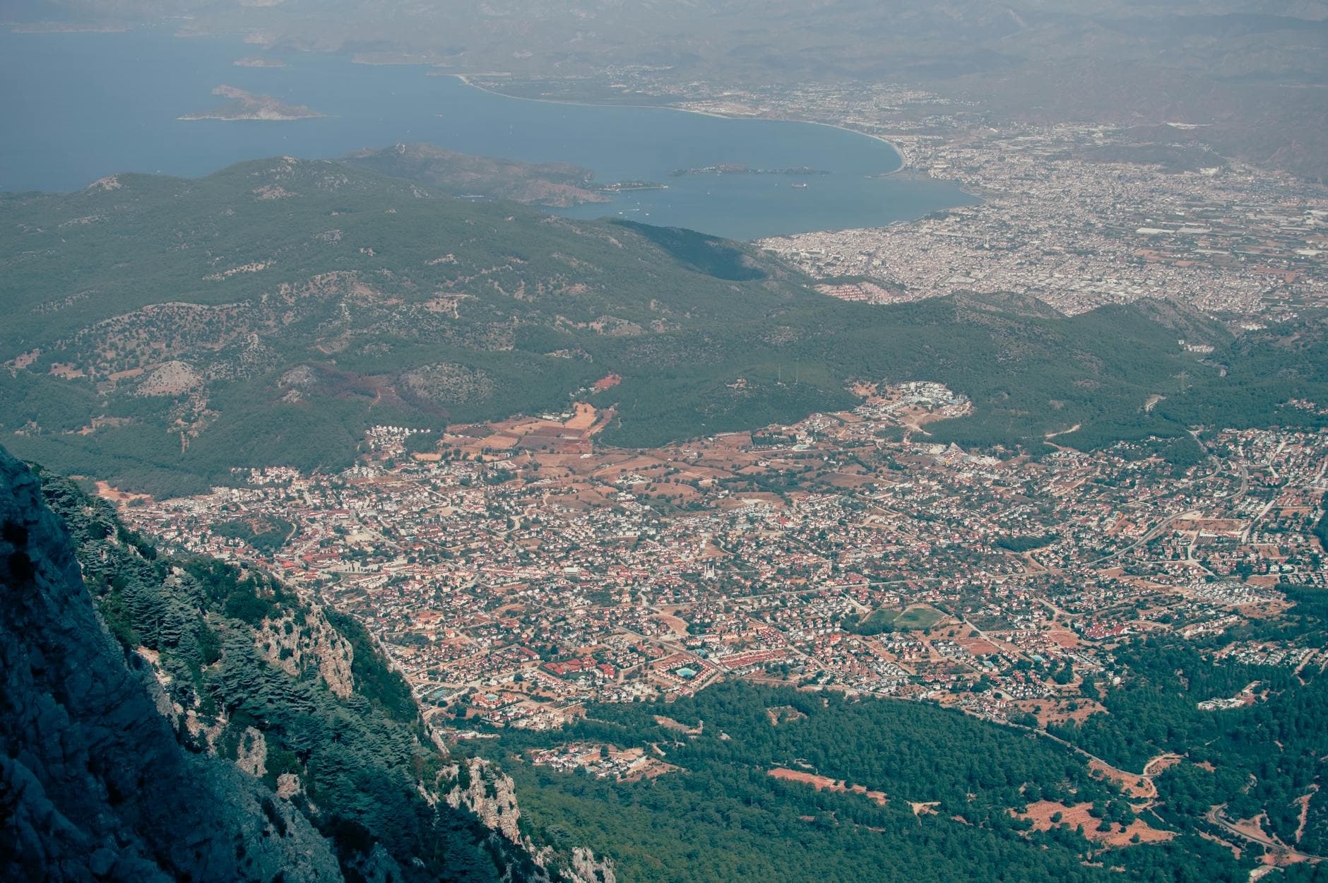 Expansive aerial view of Fethiye in Turkey, showcasing the cityscape, mountains, and coastline.