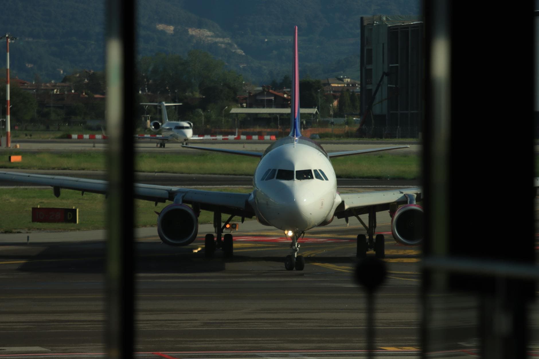 Front view of airplane on runway in Lombardia, Italy, ready for departure.