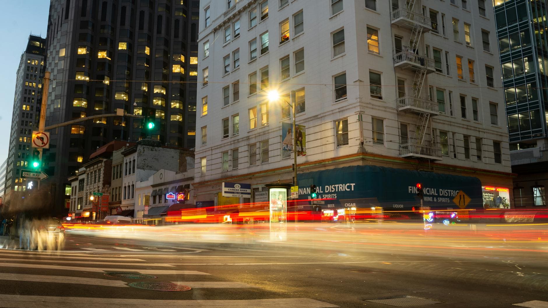 Blurred lights of traffic in downtown San Francisco at night highlighting an urban cityscape.