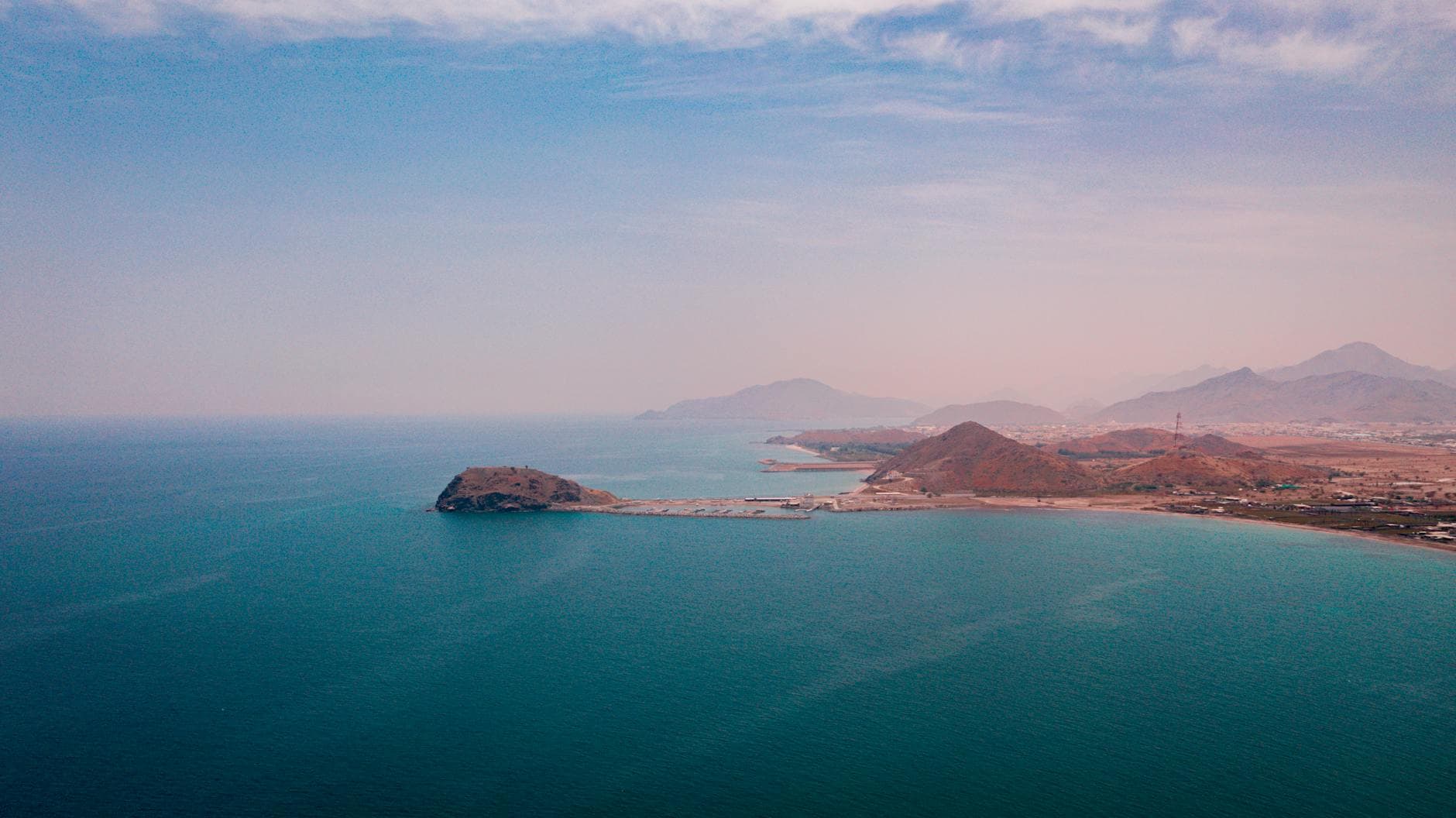 Scenic aerial view of the tranquil coastline in Al Bidya, Fujairah, UAE under a clear sky.
