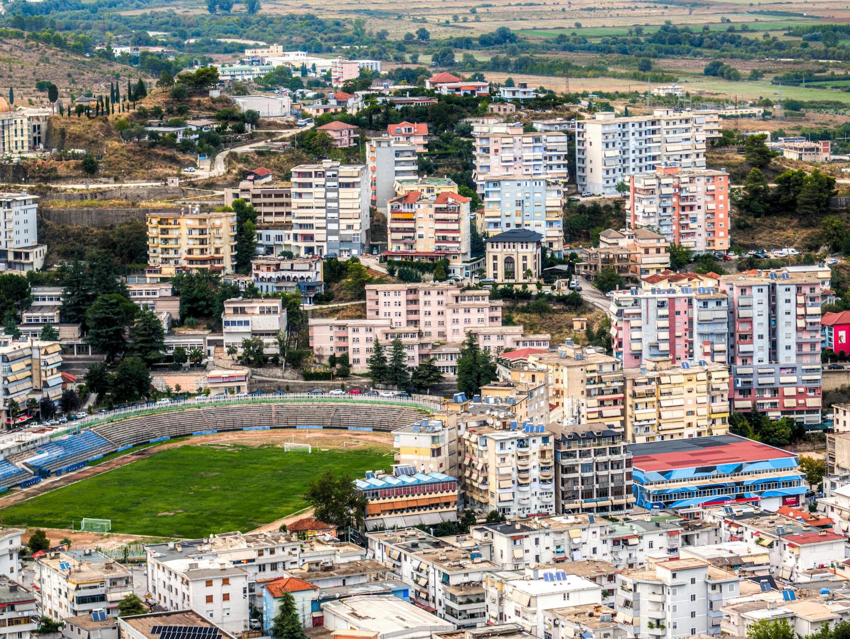 Aerial view of Gjirokastër, Albania, showcasing the densely packed cityscape and stadium.