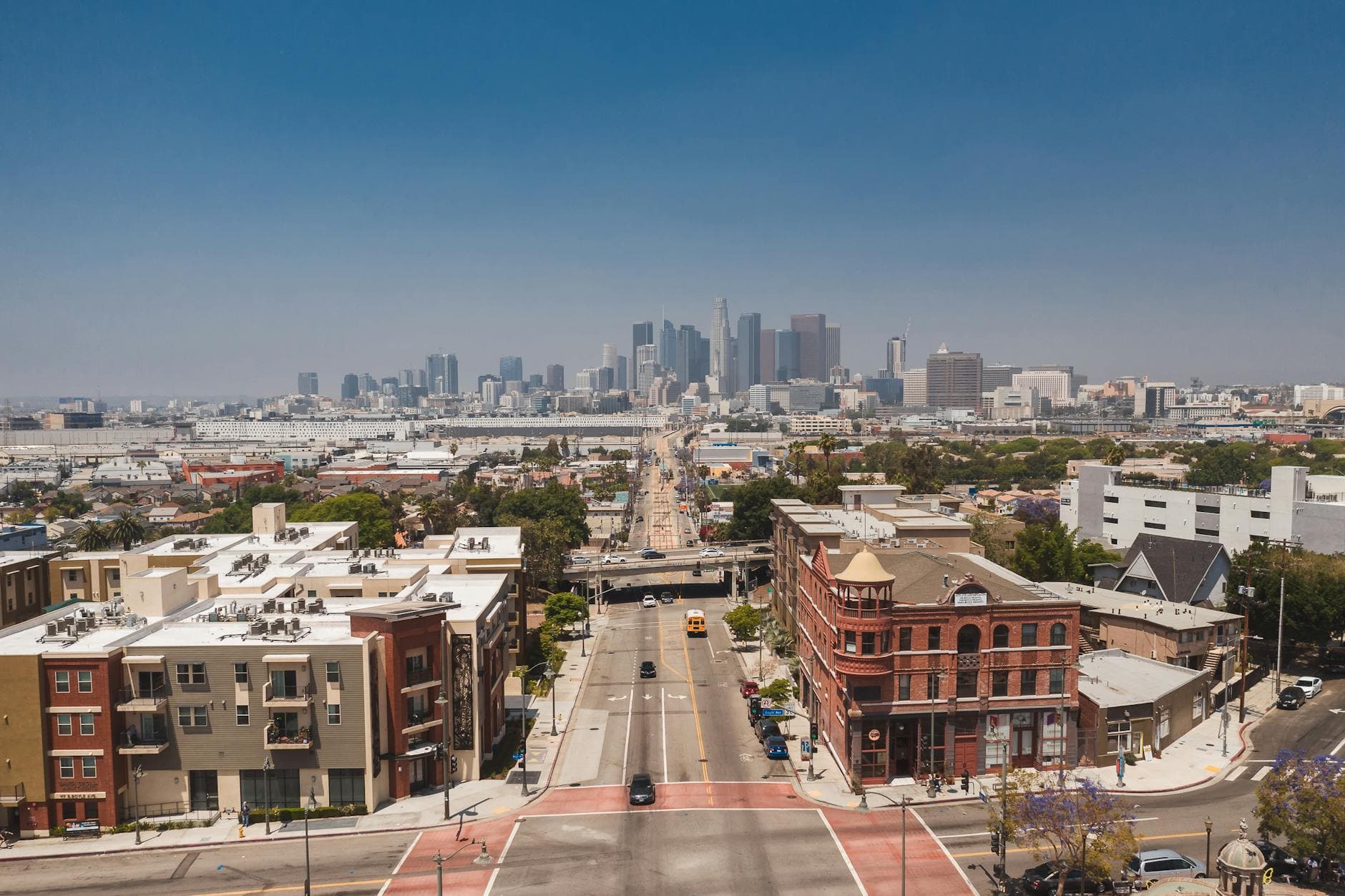 Stunning aerial perspective of downtown Los Angeles with clear blue skies, capturing the vibrant urban architecture.