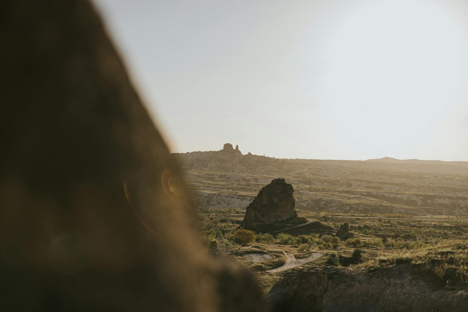 Scenic view of Göreme landscape with iconic rock formations under warm sunset light.
