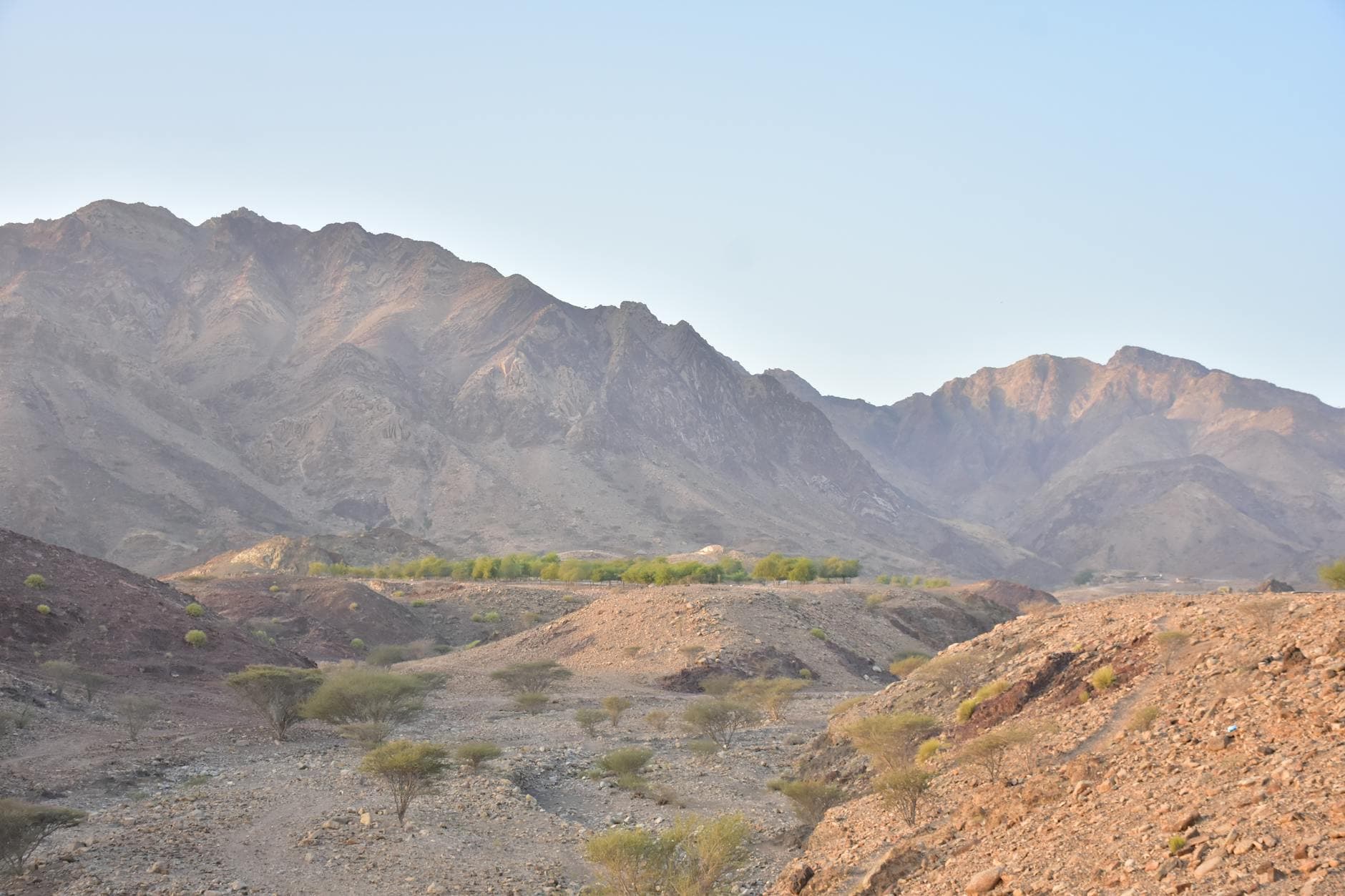 Breathtaking view of the Hatta mountain range, showcasing rugged landscapes and serene valley.