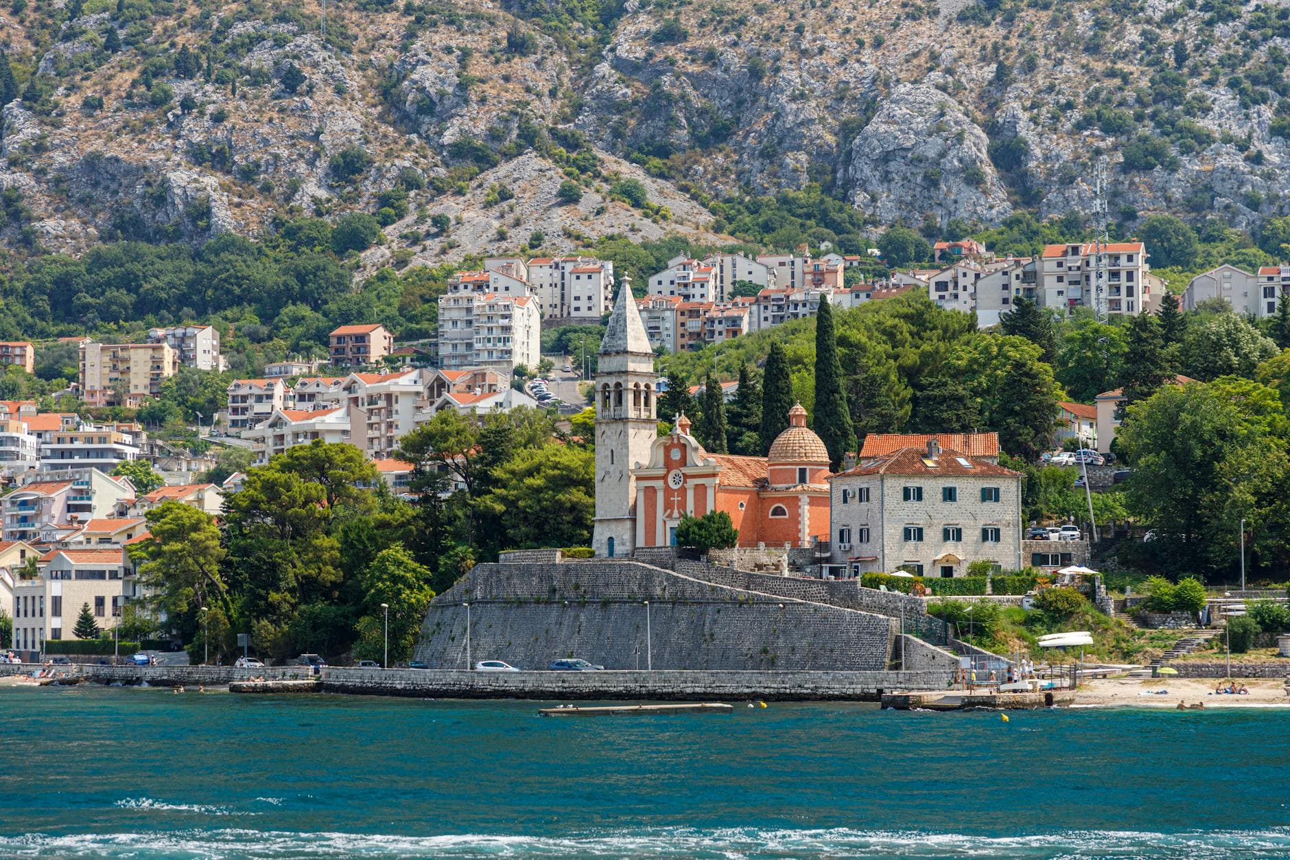 Beautiful coastal cityscape of Herceg Novi featuring a historic church by the sea.