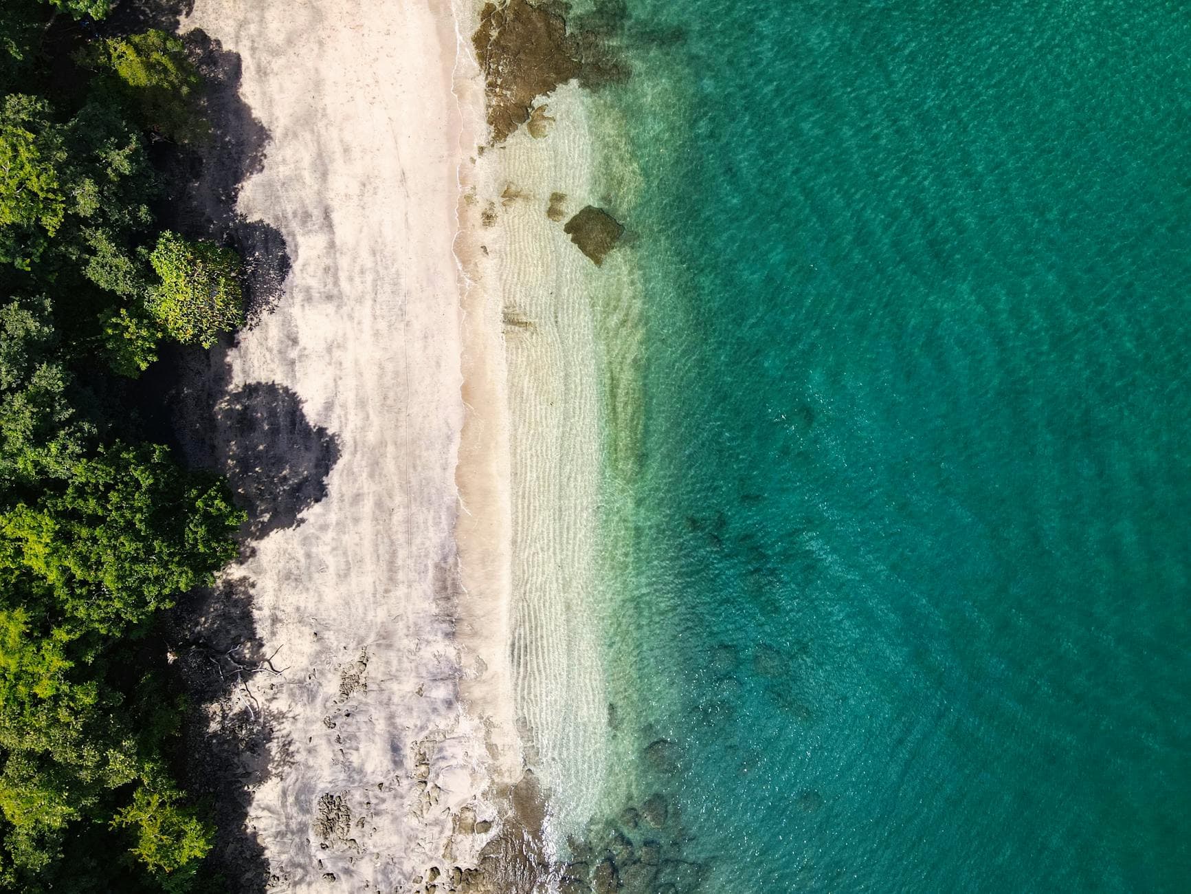 Stunning aerial view of Playa Hermosa's beach and turquoise waters in Guanacaste, Costa Rica.