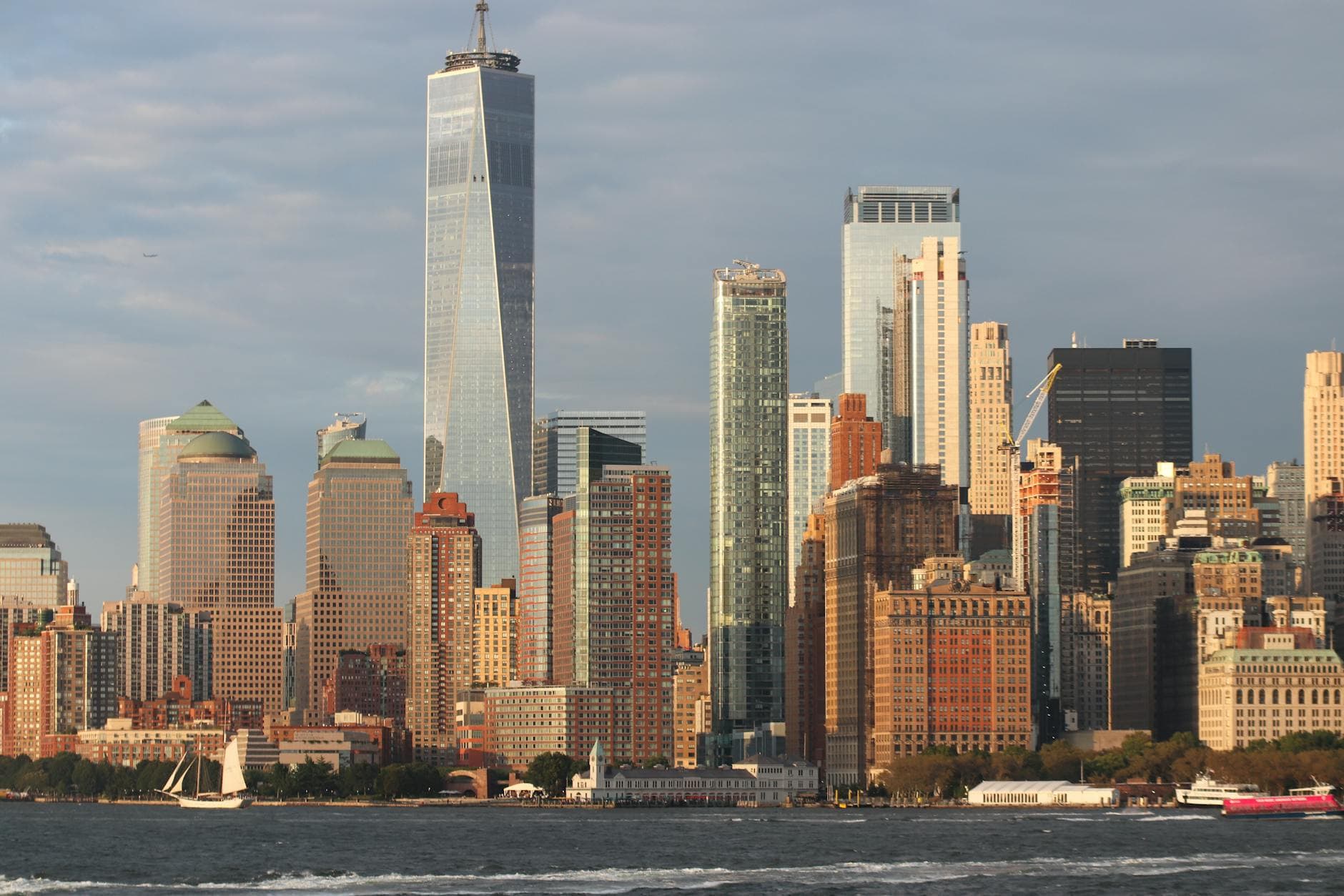 Stunning New York City skyline featuring the iconic One World Trade Center along the waterfront.
