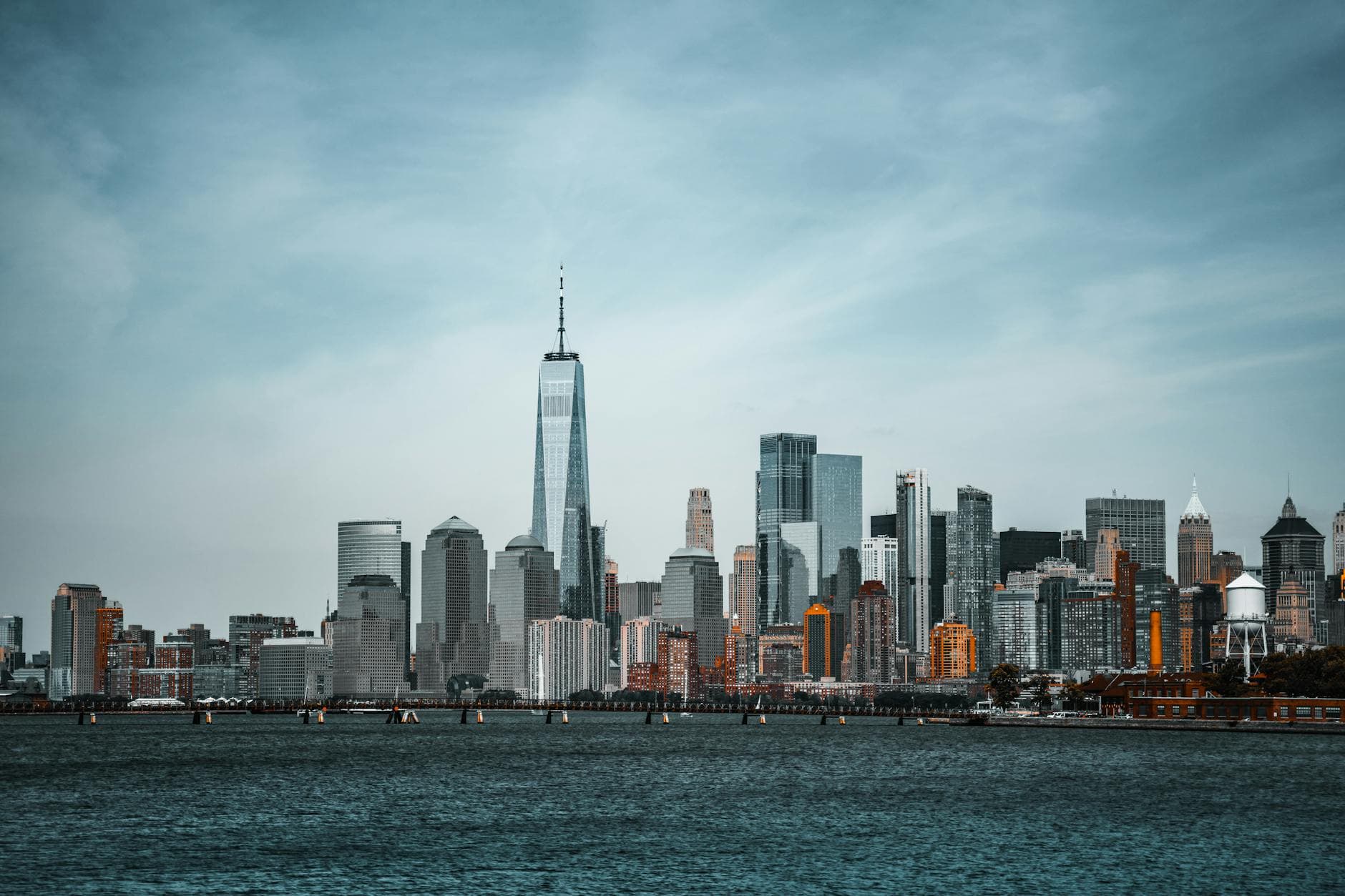 A stunning view of New York City's skyline featuring the One World Trade Center from the waterfront.