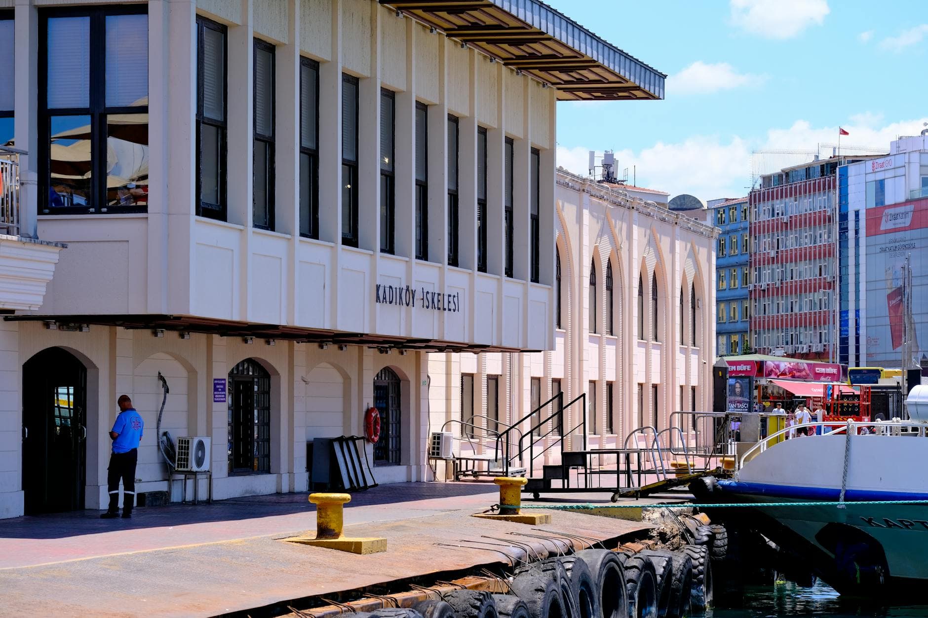 View of the Kadıköy Ferry Terminal in Istanbul with waterfront and boats.
