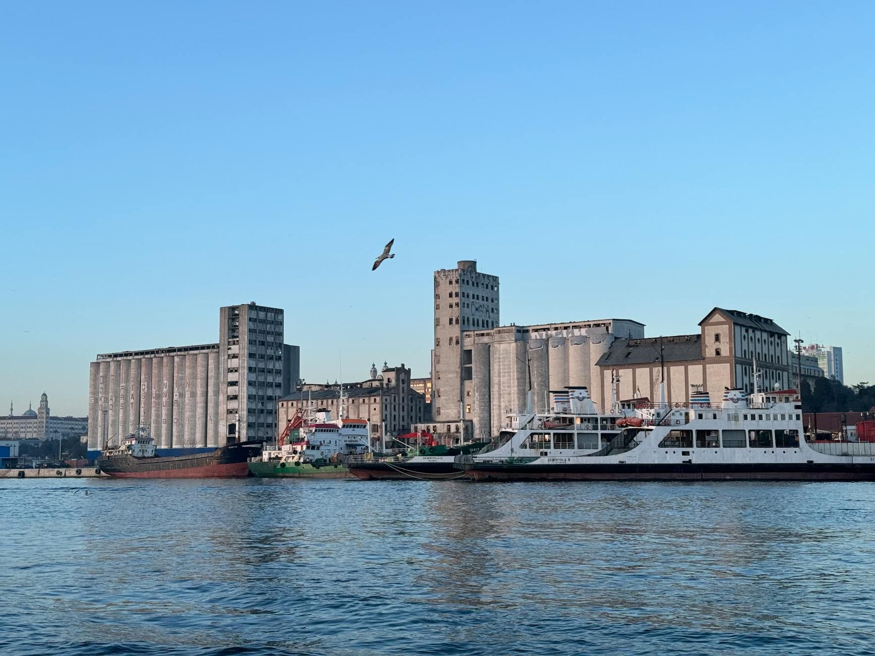 Scenic view of Haydarpaşa Port, Istanbul with ships and industrial buildings by the seaside.