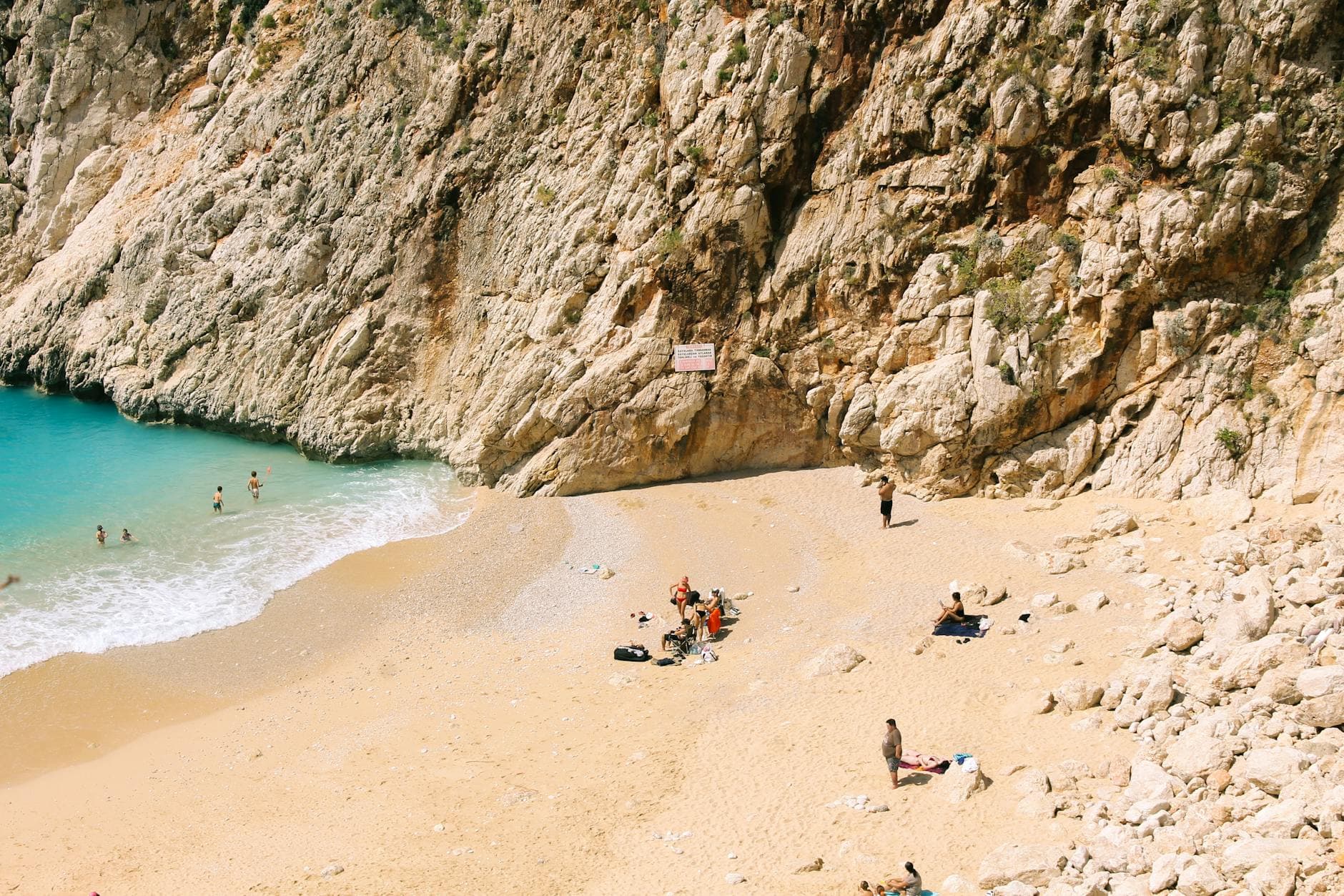 Aerial photograph of Kaputas Beach in Turkey with sunbathers and swimmers enjoying the summer sun.
