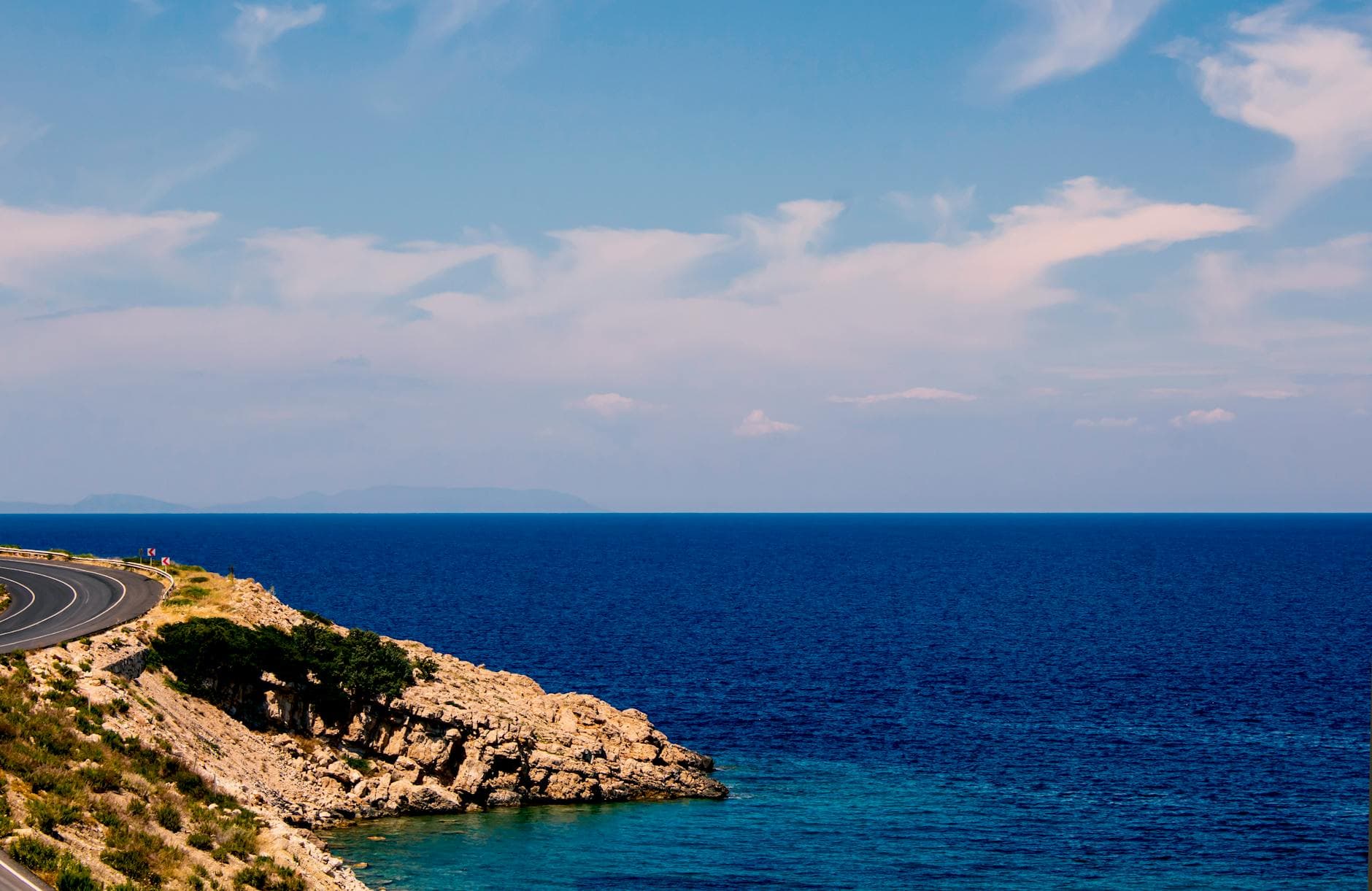 Experience the stunning coastal road view in Karaburun, İzmir, Türkiye with deep blue sea vistas.
