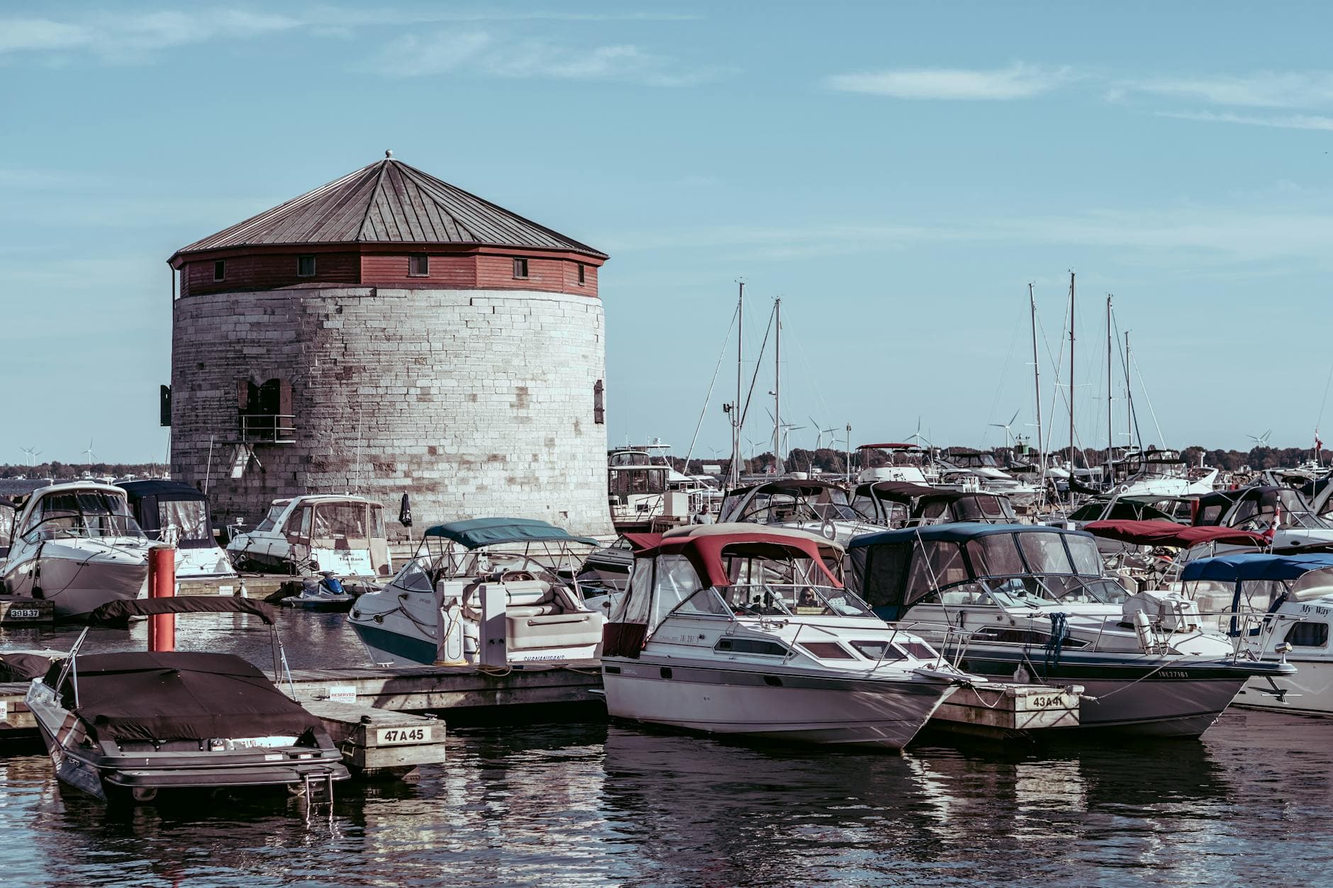 Scenic view of Shoal Tower surrounded by boats in Kingston Harbor, Ontario, Canada.