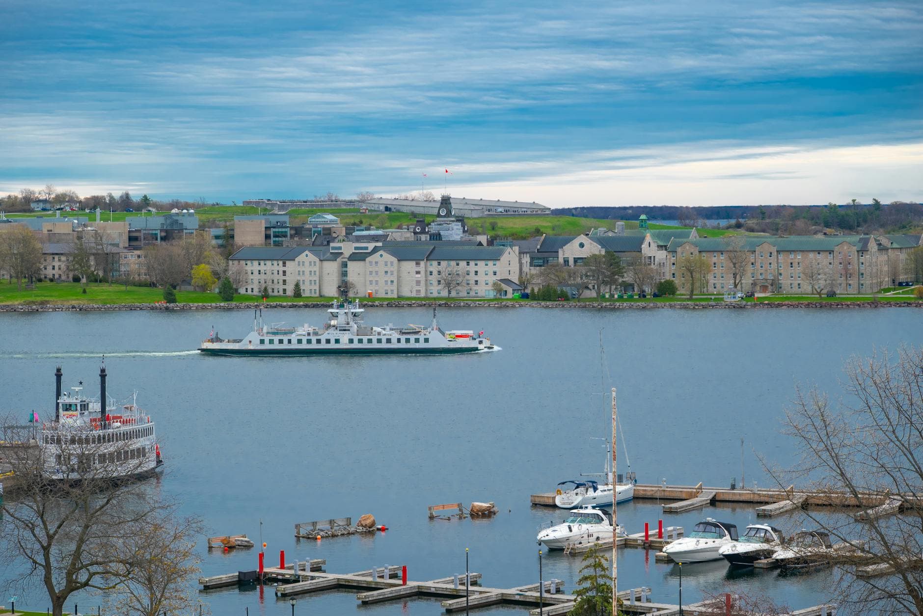 A scenic view of Kingston's waterfront with boats and historic architecture on a clear day.